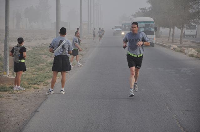 Major Darrin Bender crosses the finish line in 3rd place in the midst of a dust storm. Photo: Sgt. 1st Class Adam V. Shaw