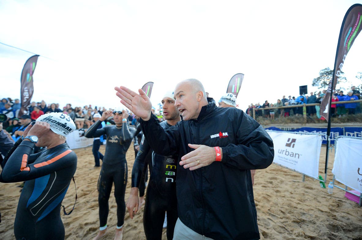 Ironman CEO Andrew Messick, who will retire soon, talks with a triathlete at Ironman Melbourne.