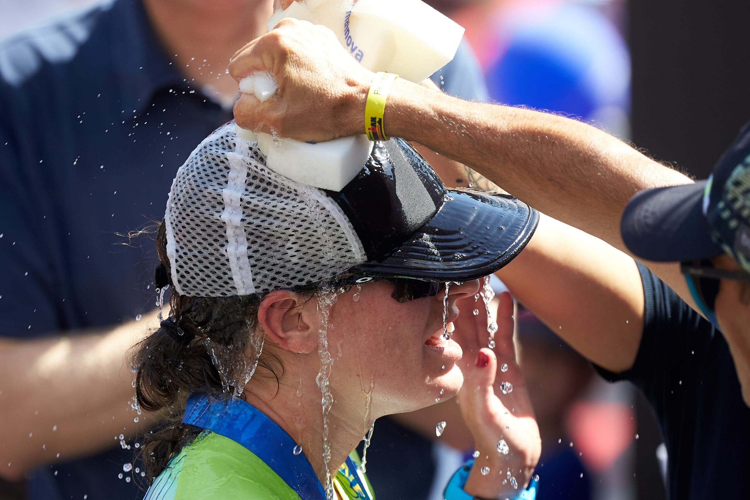 Skye Moench cools off using sponges at the Ironman European Championship.