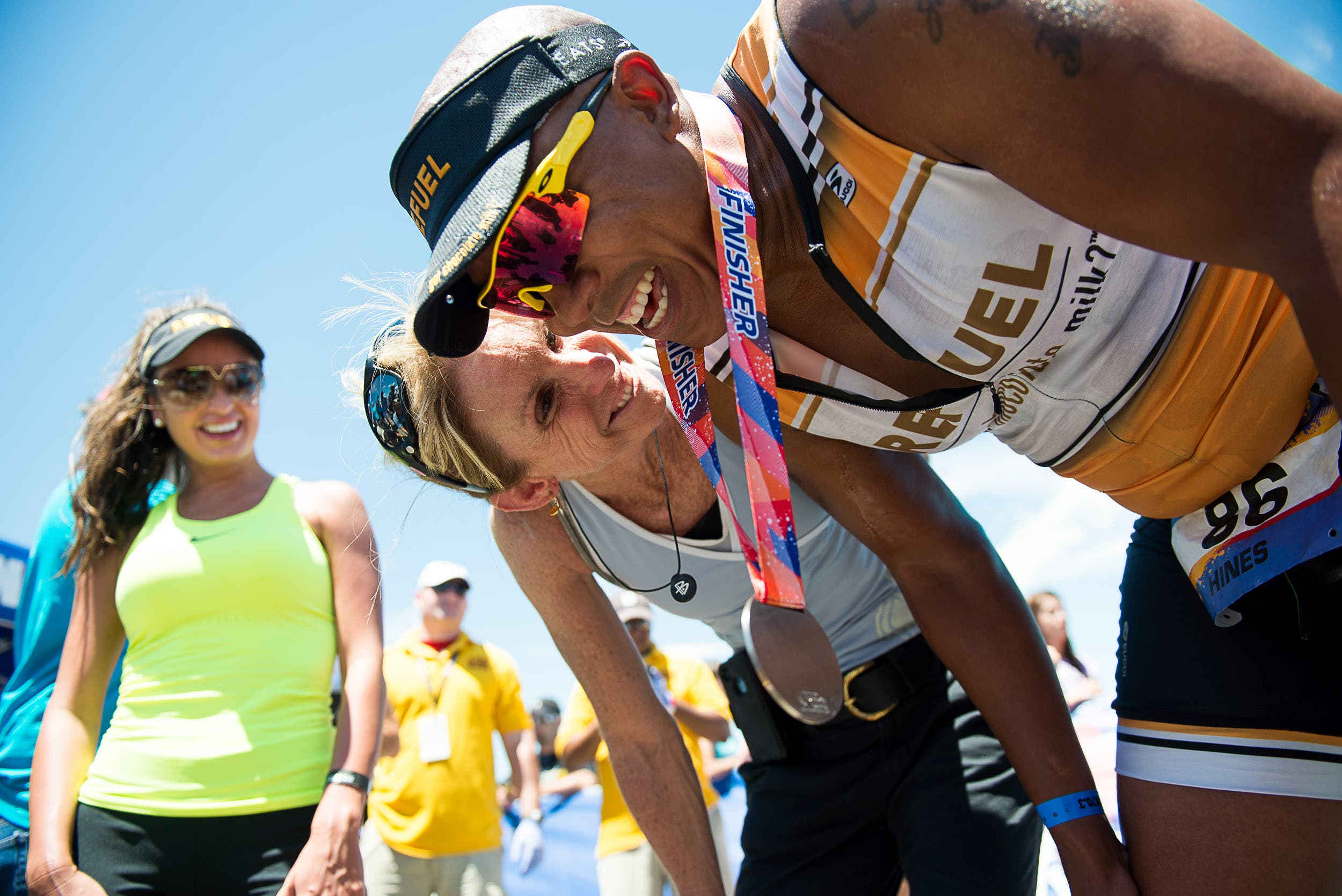 Coach Paula Newby-Fraser greets Hines Ward at the finish line in Lawrence.