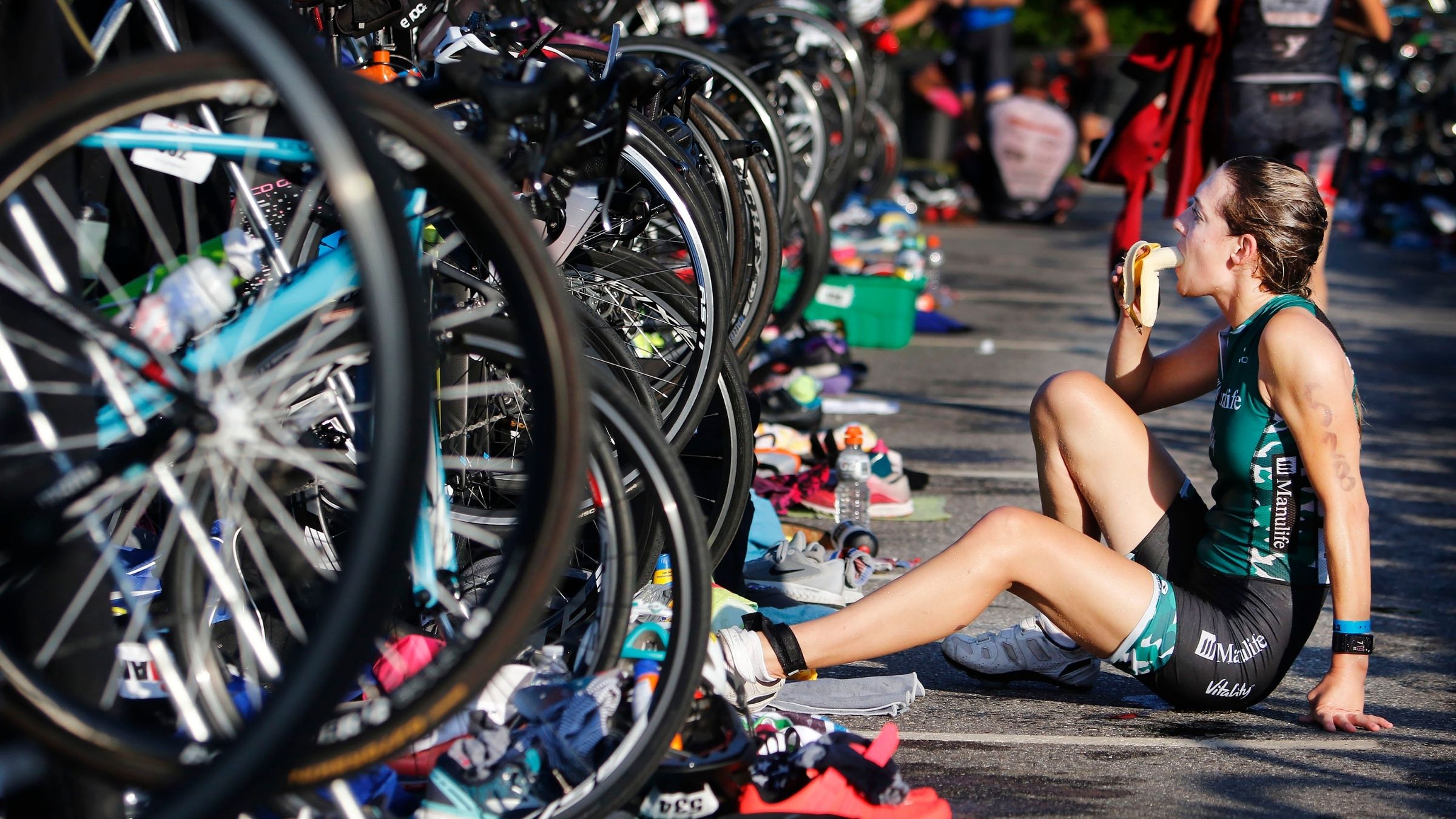 An athlete eats in transition as part of her 70.3 nutrition plan.