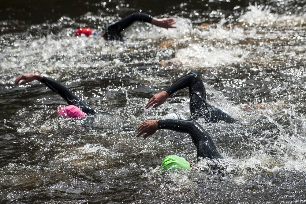 Image of triathletes swimming during a race.