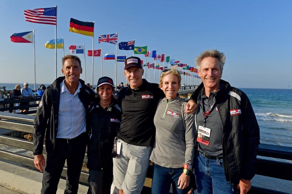 (L-R) Six-time Ironman World Champion Dave Scott, Ironman World Championship Race Director Diana Bertsch, Ironman CEO Andrew Messick, 8-Time Ironman World Champion Paula Newby-Fraser, and Six-time Ironman World Champion Mark Allen pose for a photo during the 2018 Parade of Nations prior to the 70.3 World Championships