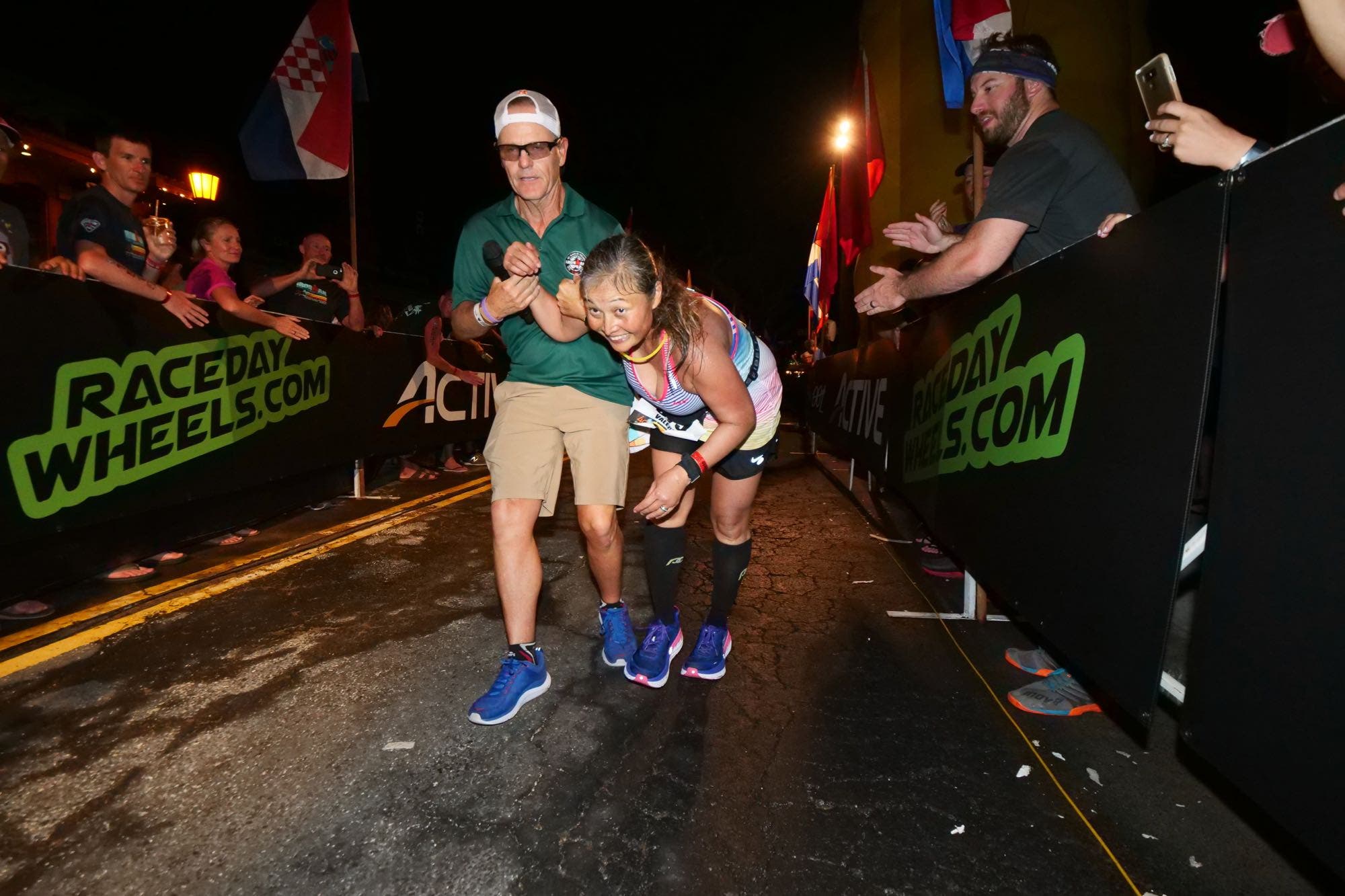 A Mike Reilly retirement photo looking back at helping athletes across a finish line.