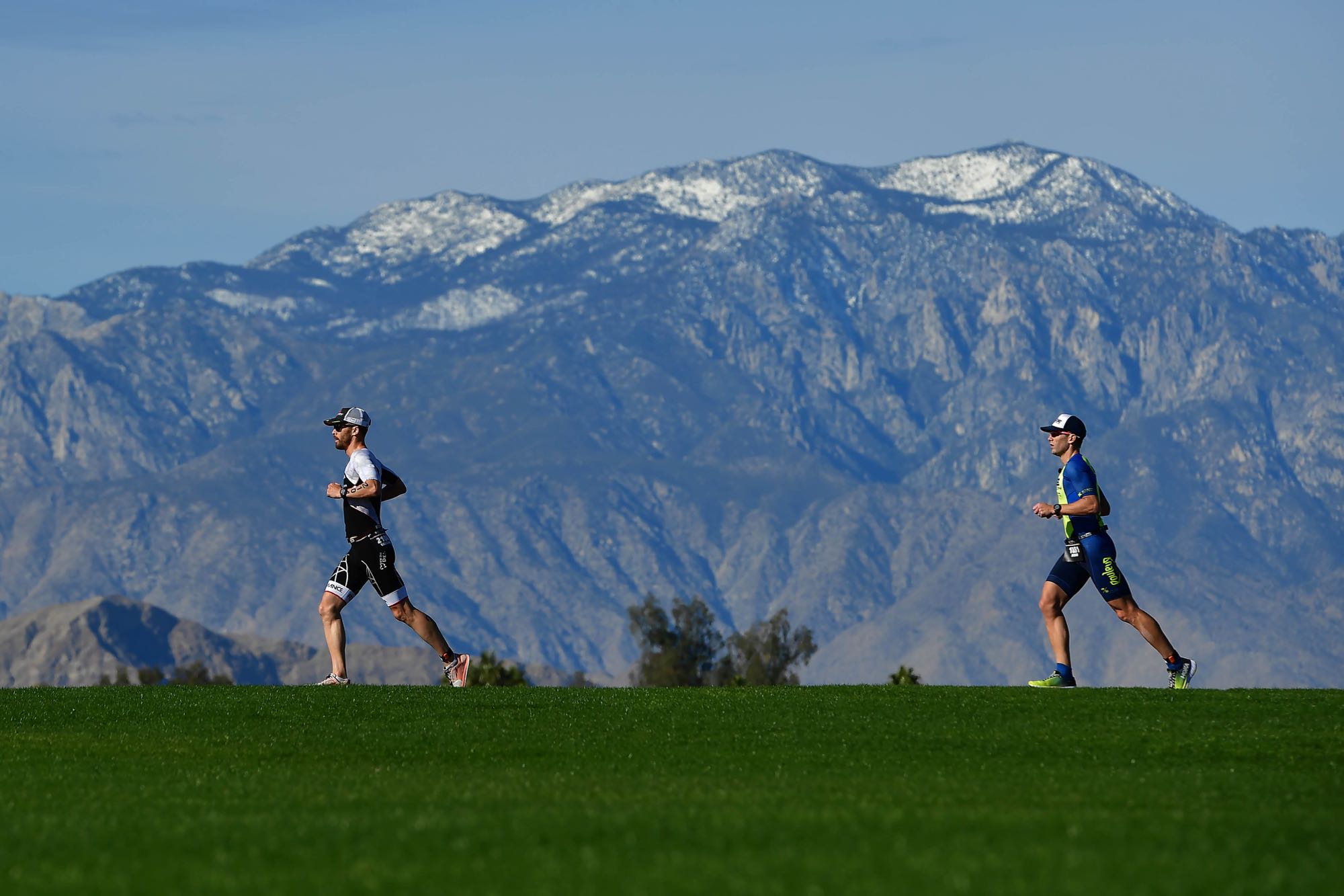Athletes embark on the 13.1-mile run course beneath the skyline of the snow capped San Jacinto Mountains. Photo: Donald Miralle/Getty Images for Ironman