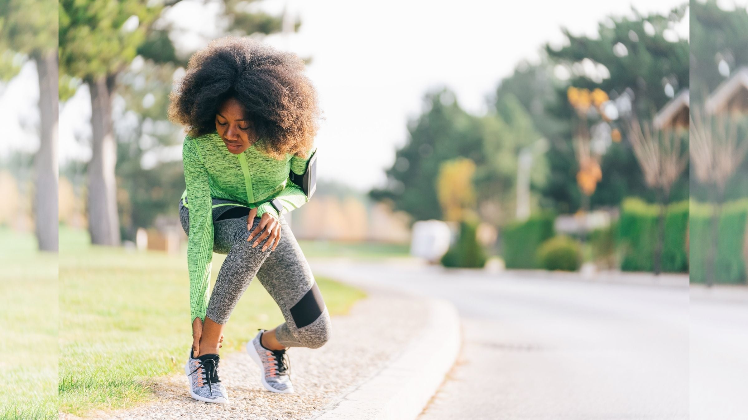 A woman clutches her ankle in pain, wondering how to take care of her running injury until she can see a doctor.