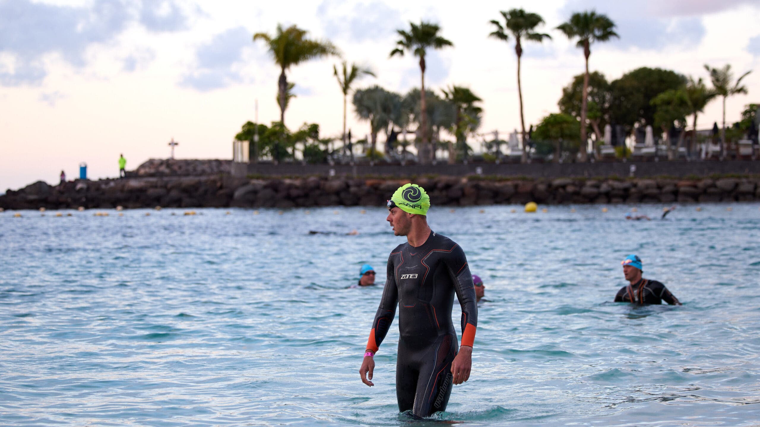 Beginner triathletes benefit from wearing a wetsuit not so much for warmth, but for better body positioning in the water.