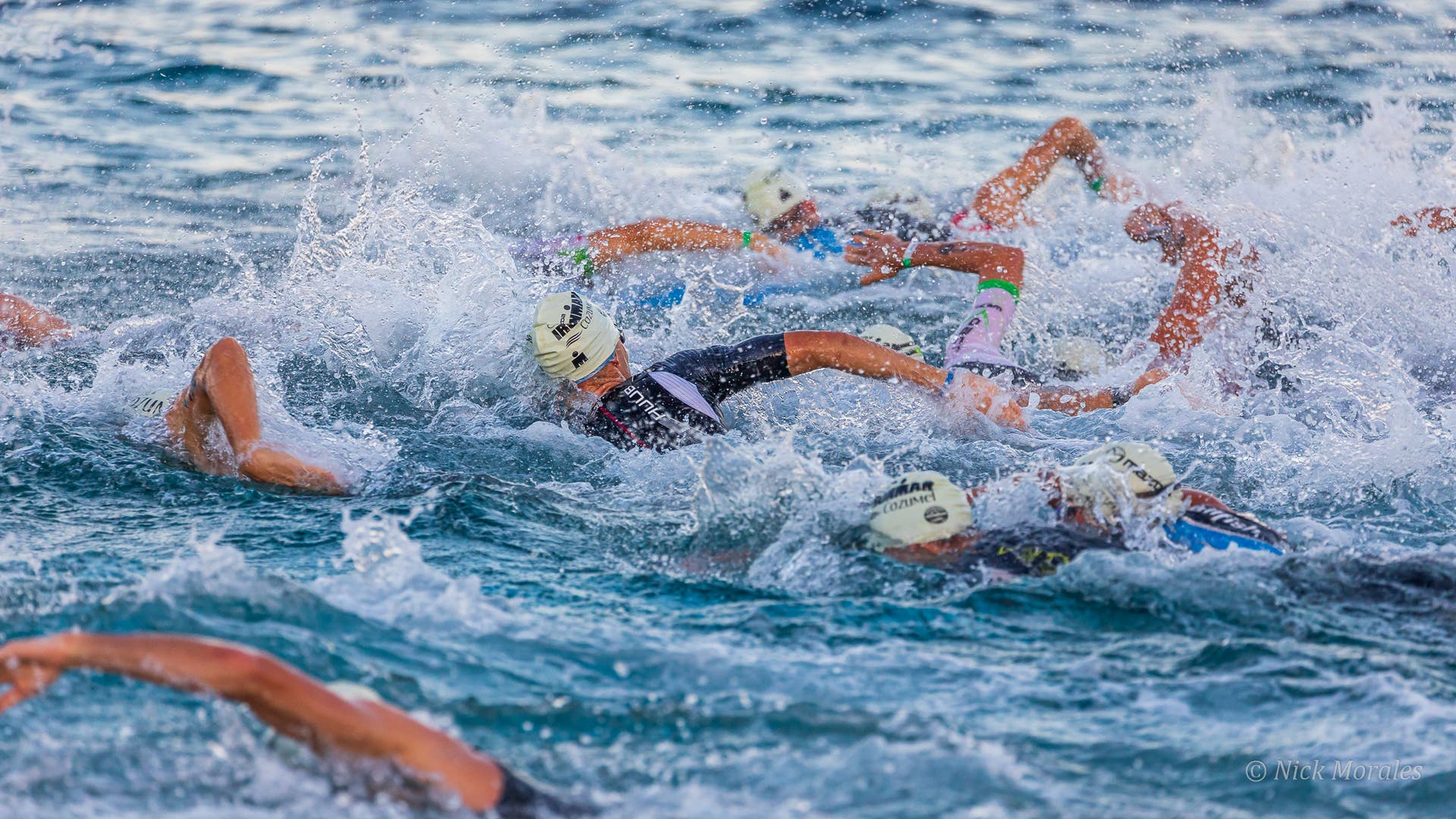 Athletes swim at Ironman Cozumel, one of the best Ironman races in North America.