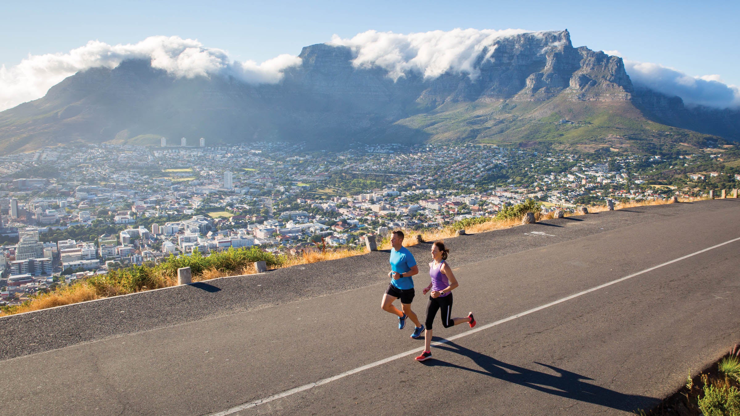 Fit couple running in the mother city - cape town, table mountain