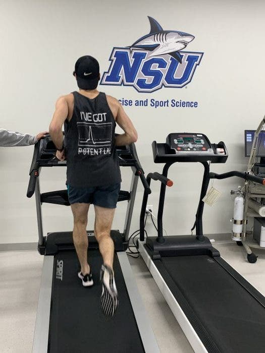 Young man running on a treadmill at the NeuroSport lab