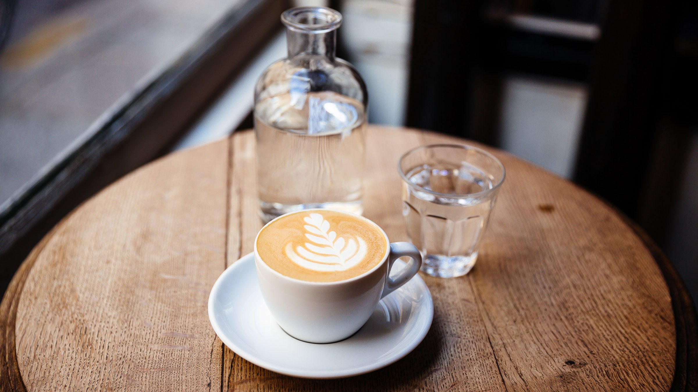 Cup of cappuccino on the table in a coffee shop