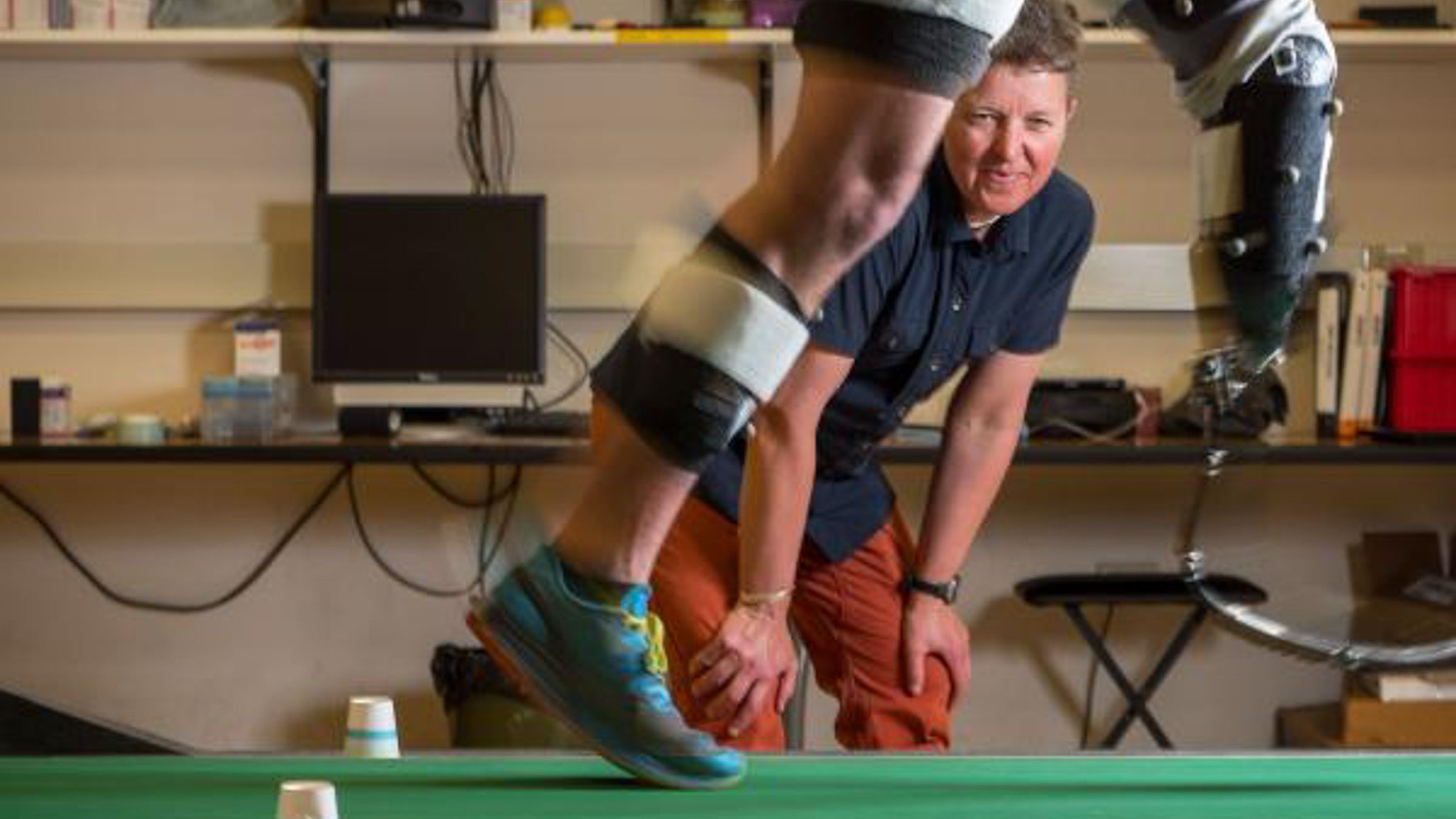 Dr. Alena Grabowski watches a runner with a blade prosthetic