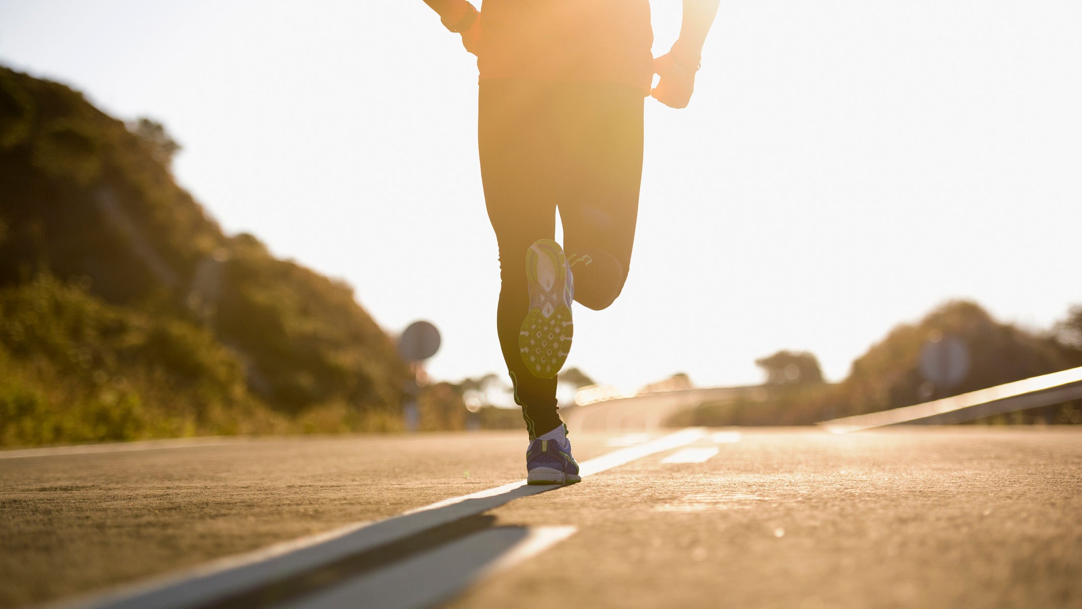 A person running on a paved surface as they complete a one-hour hill and tempo run.