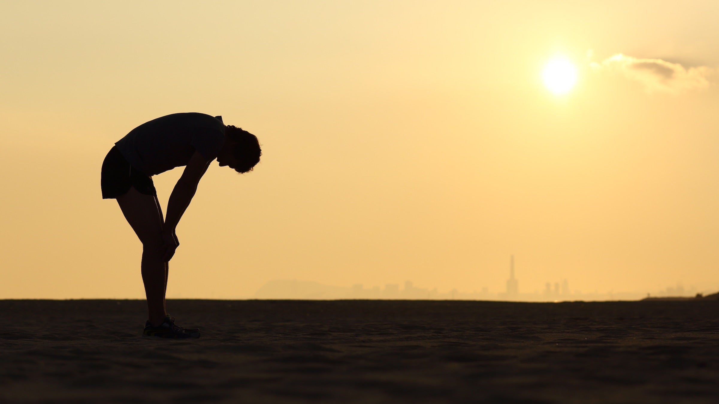 tired runner hands on knee