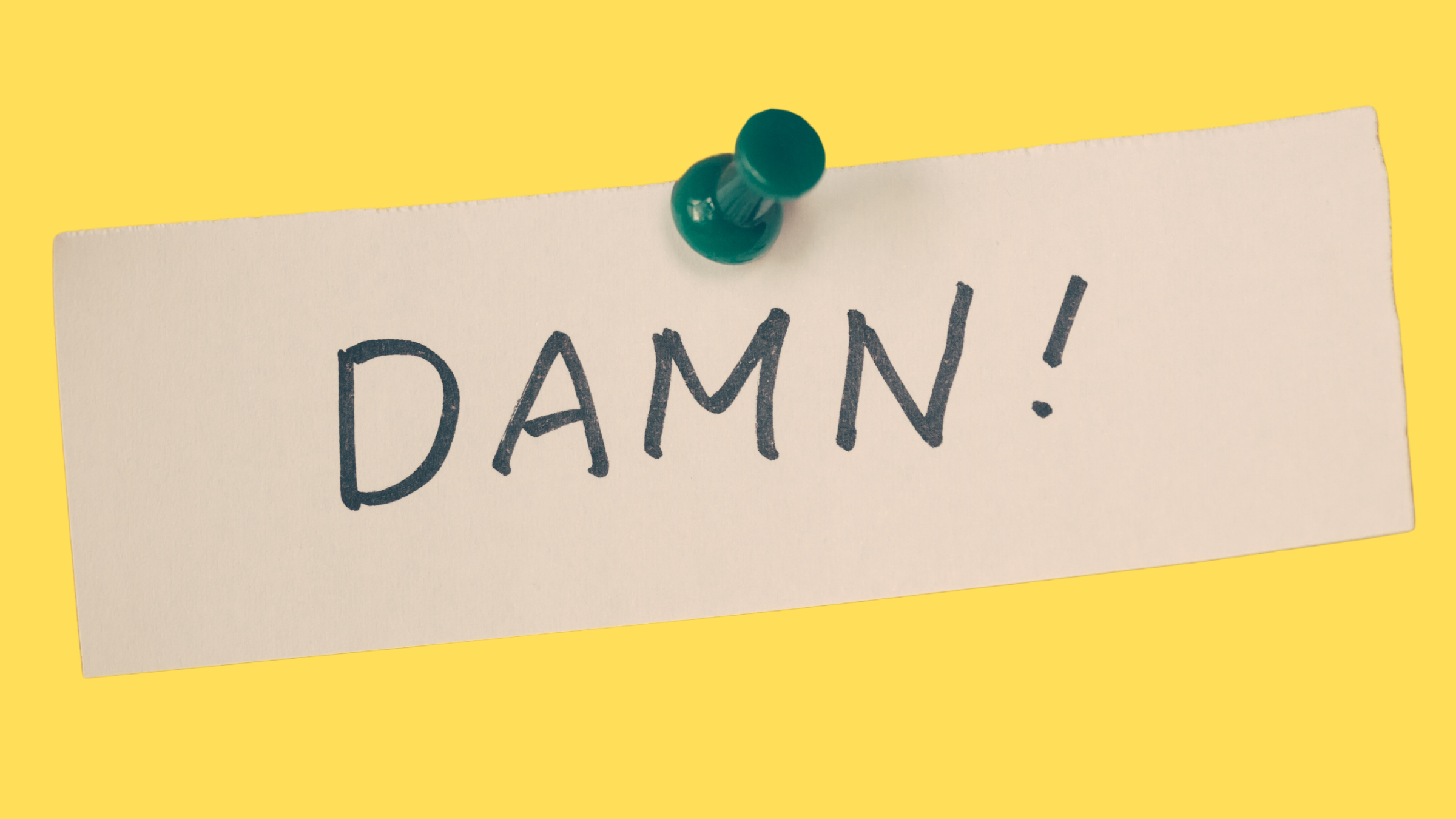 Note with "damn" written on it, pinned to a yellow board
