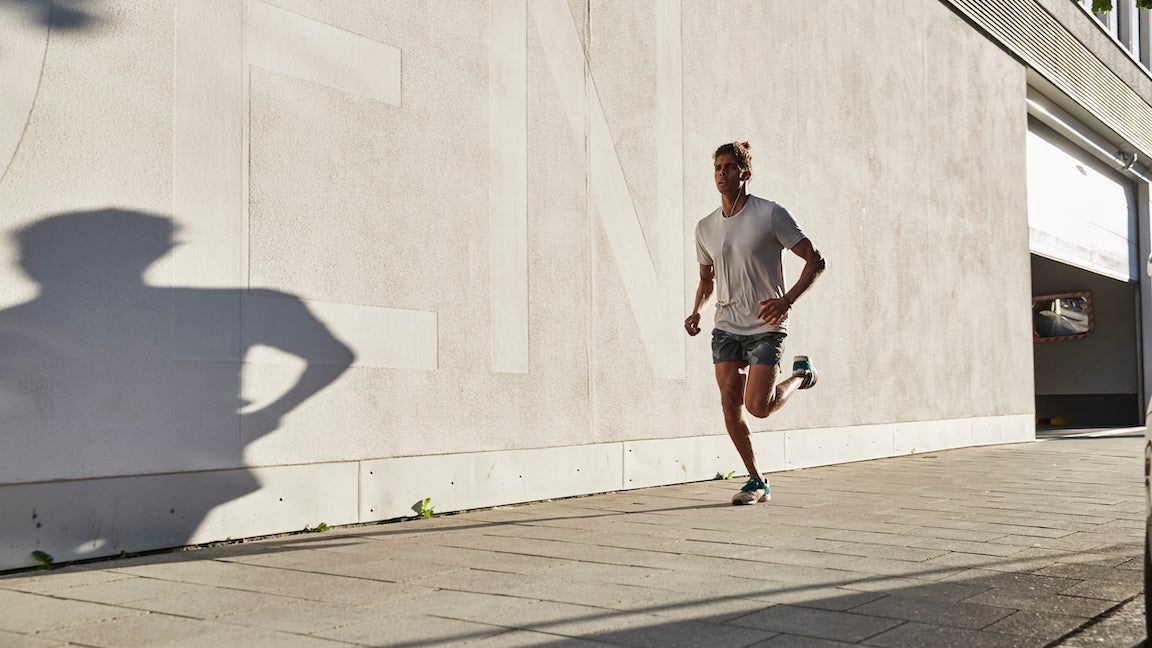 Young man running in the city.
