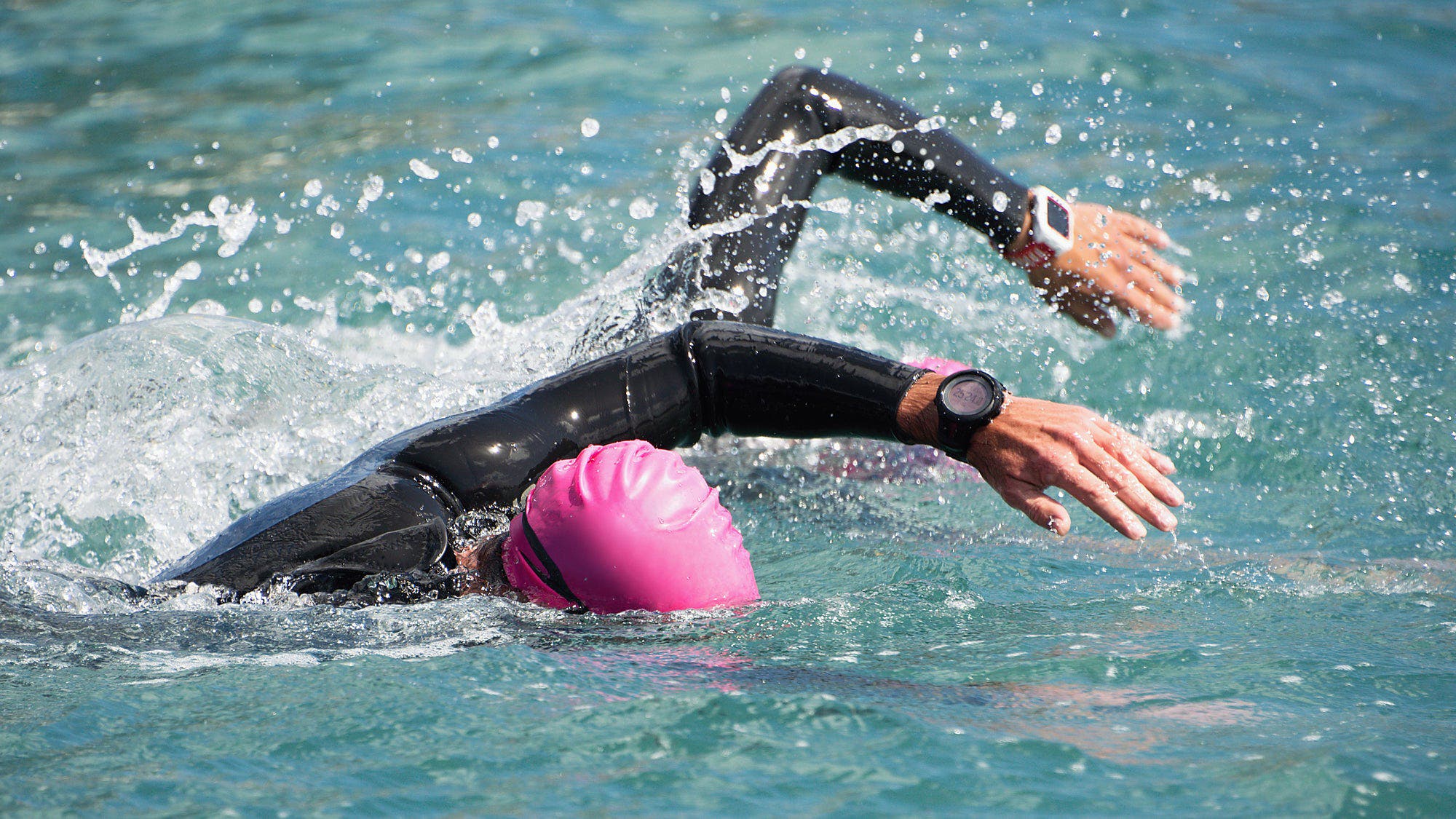 Swimmers in wetsuits