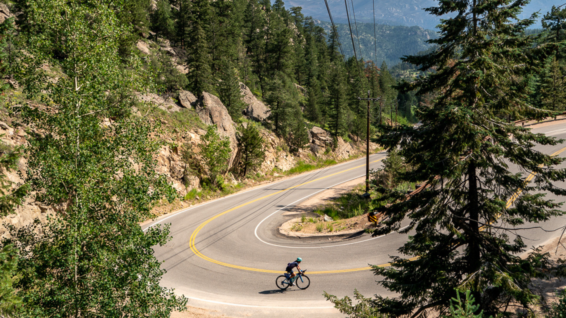 Mirinda Carfrae climbs a mountain switchback on her bike.