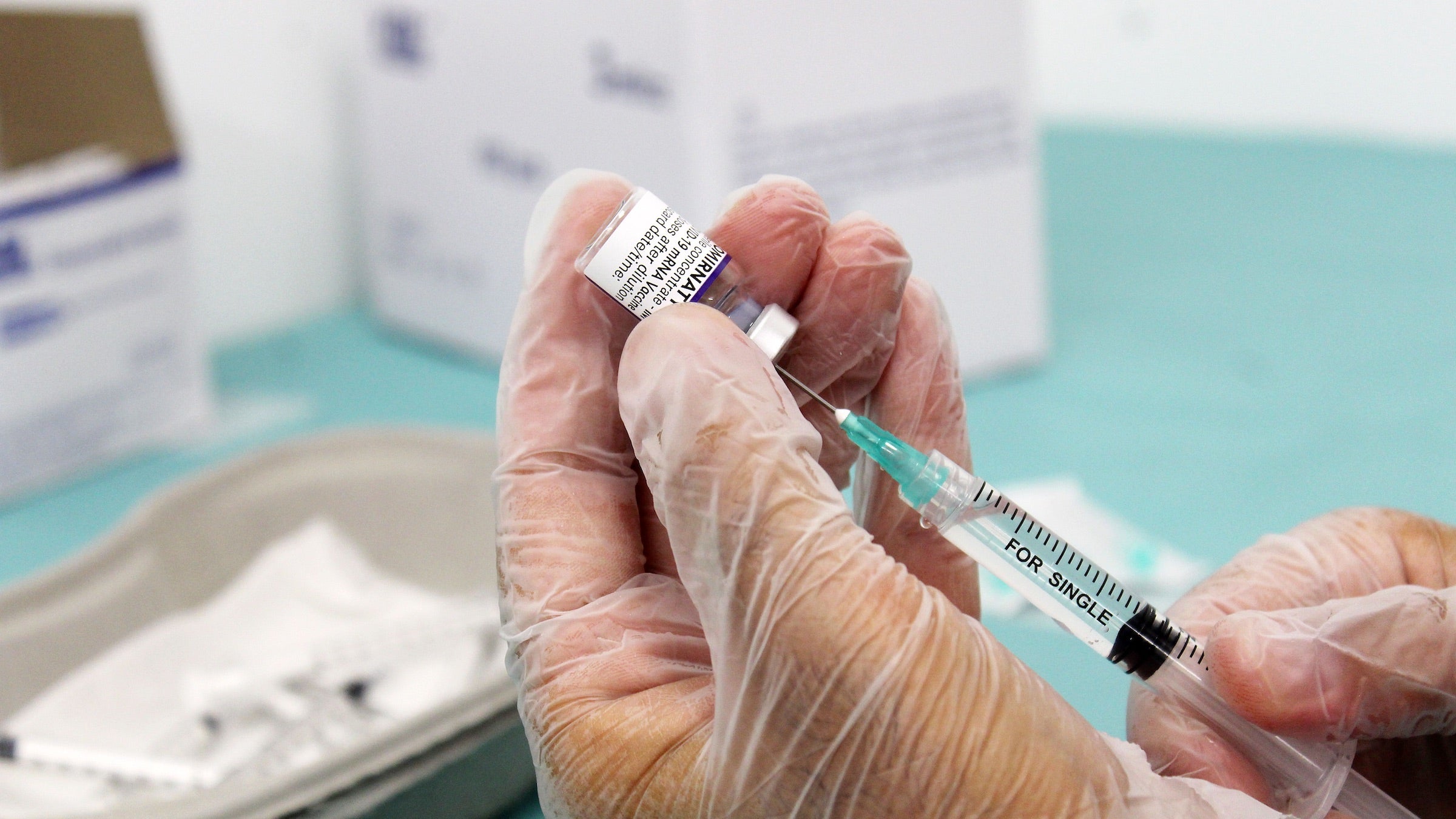 A nurse prepares a dose of the COVID-19 vaccine from Moderna. 