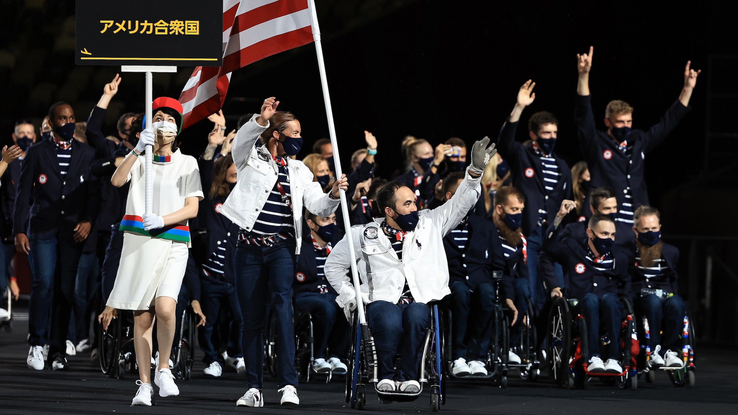 Flagbearers Melissa Stockwell and Charles Aoki lead Team USA into the opening ceremonies of the Tokyo Paralympic Games.
