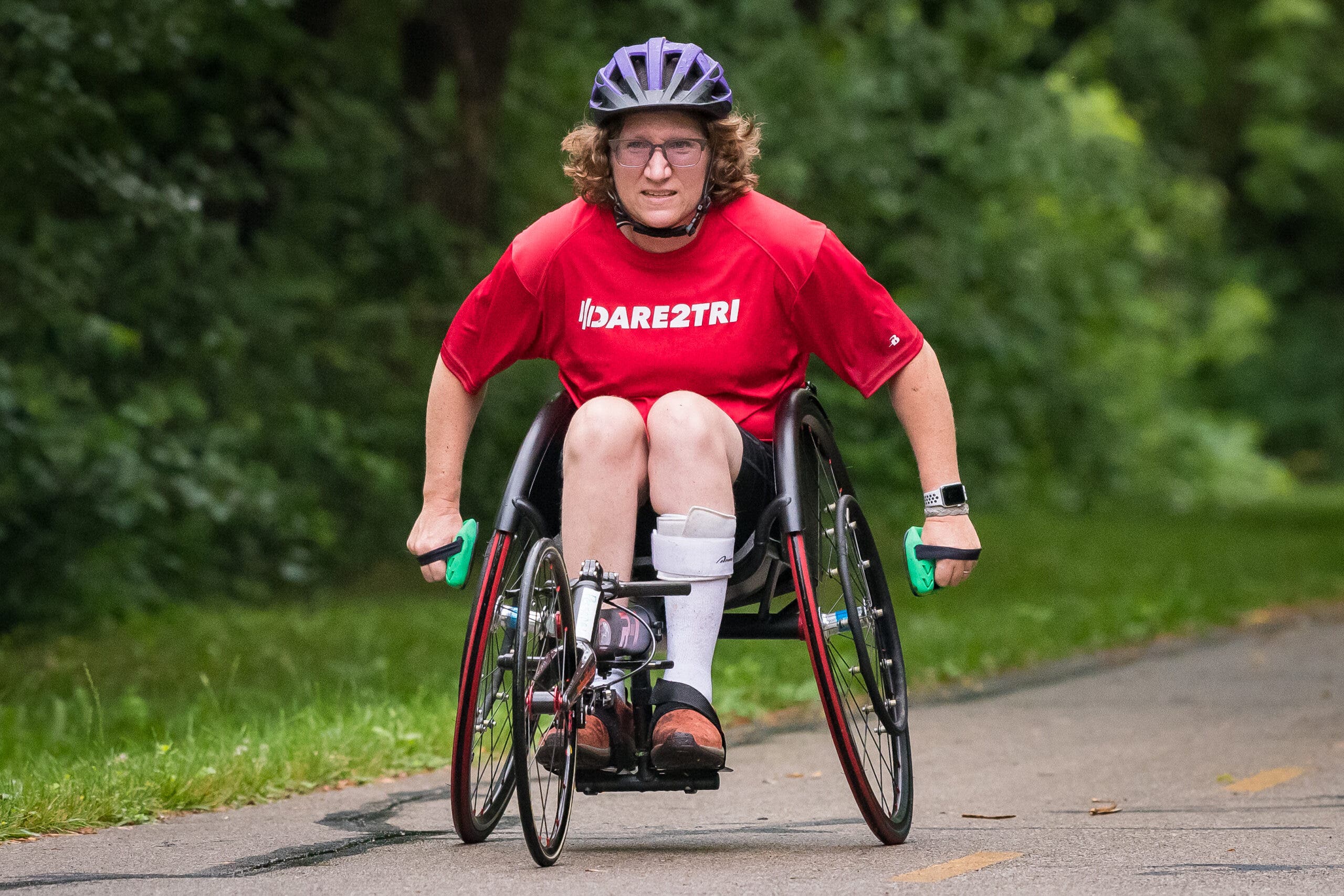 A wheelchair athlete pushes a racing wheelchair during a triathlon.