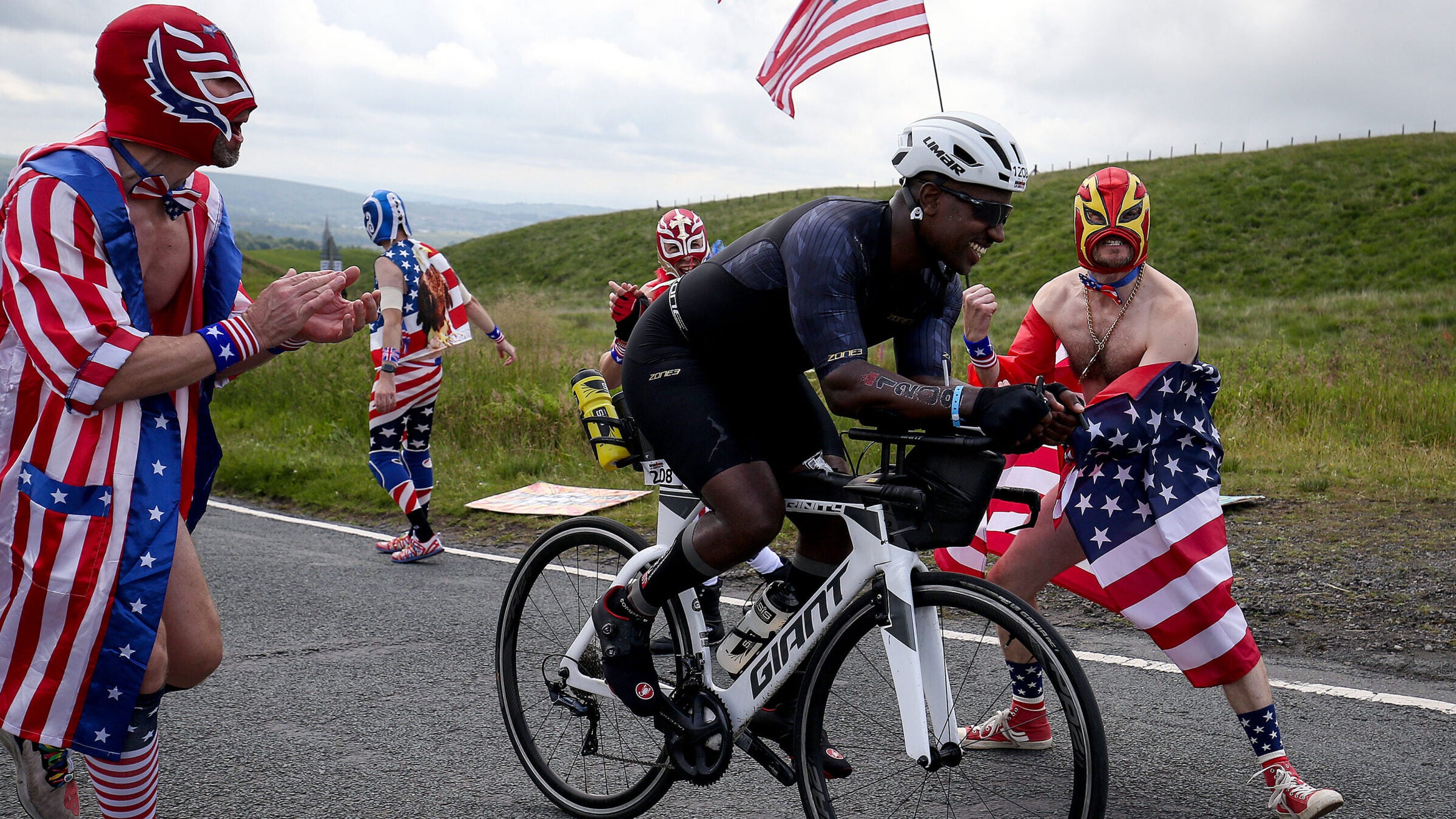 Dressed up spectators cheer on athletes competing in the bike section of Ironman UK on July 4.