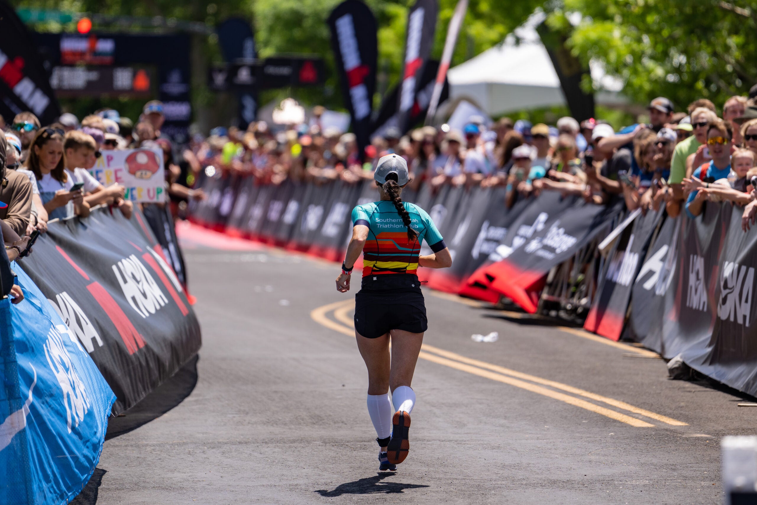 What's a good finishing time for a triathlon? A triathlete wonders as she runs to the finish line.