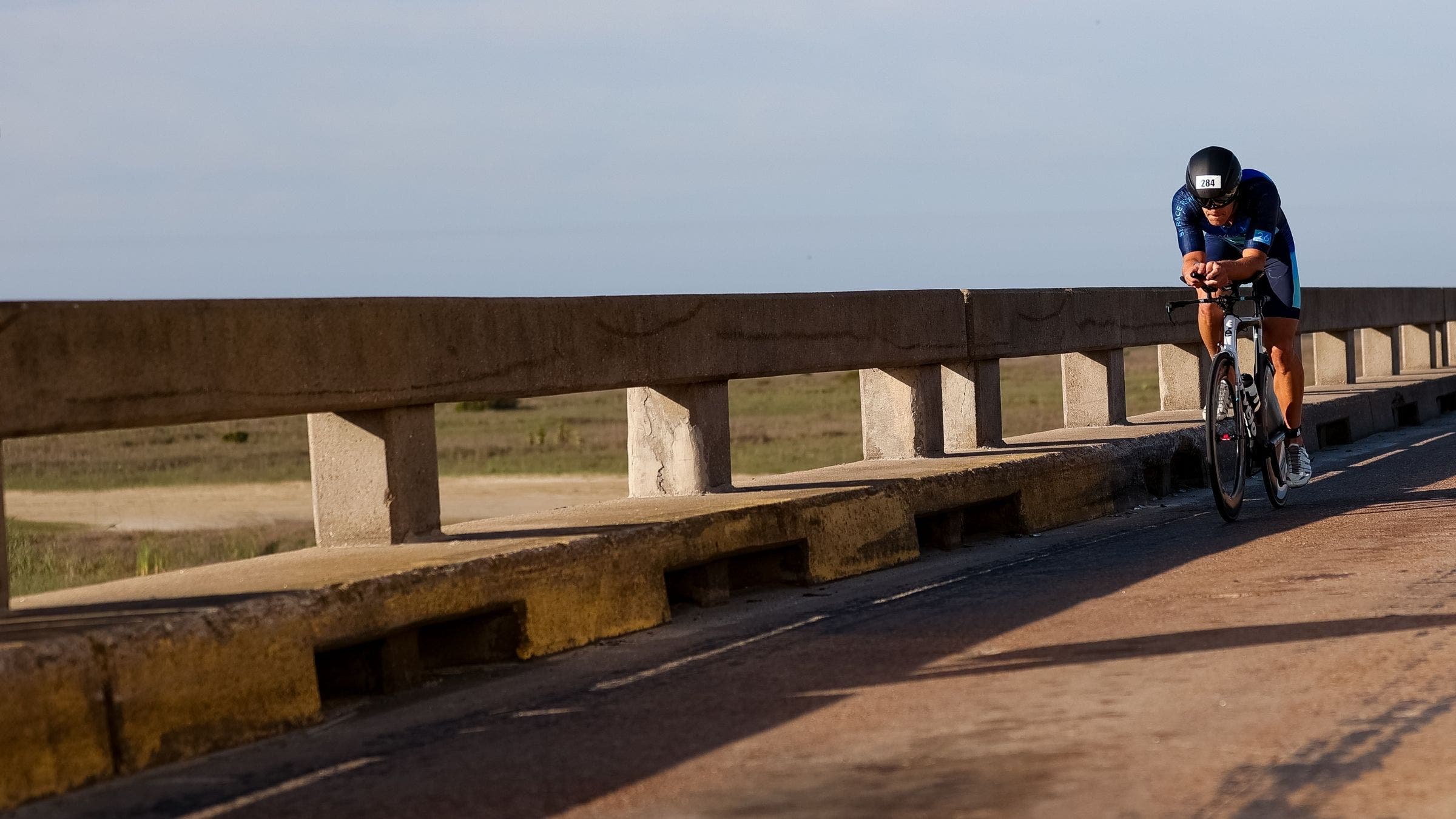 An triathlete makes his way through the Ironman 70.3 Texas bike course.