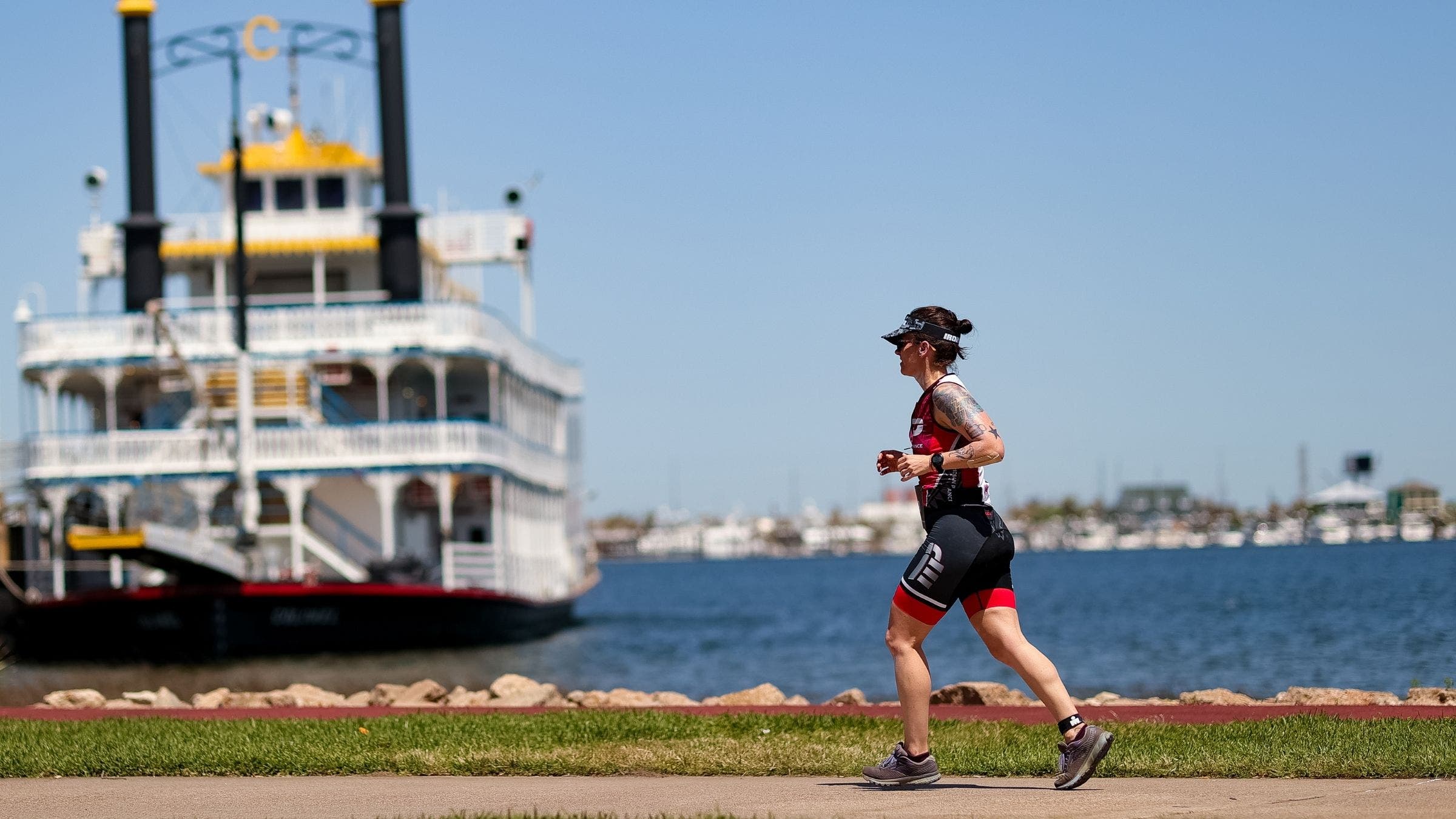 A triathlete makes her way through the Ironman 70.3 Texas run course.