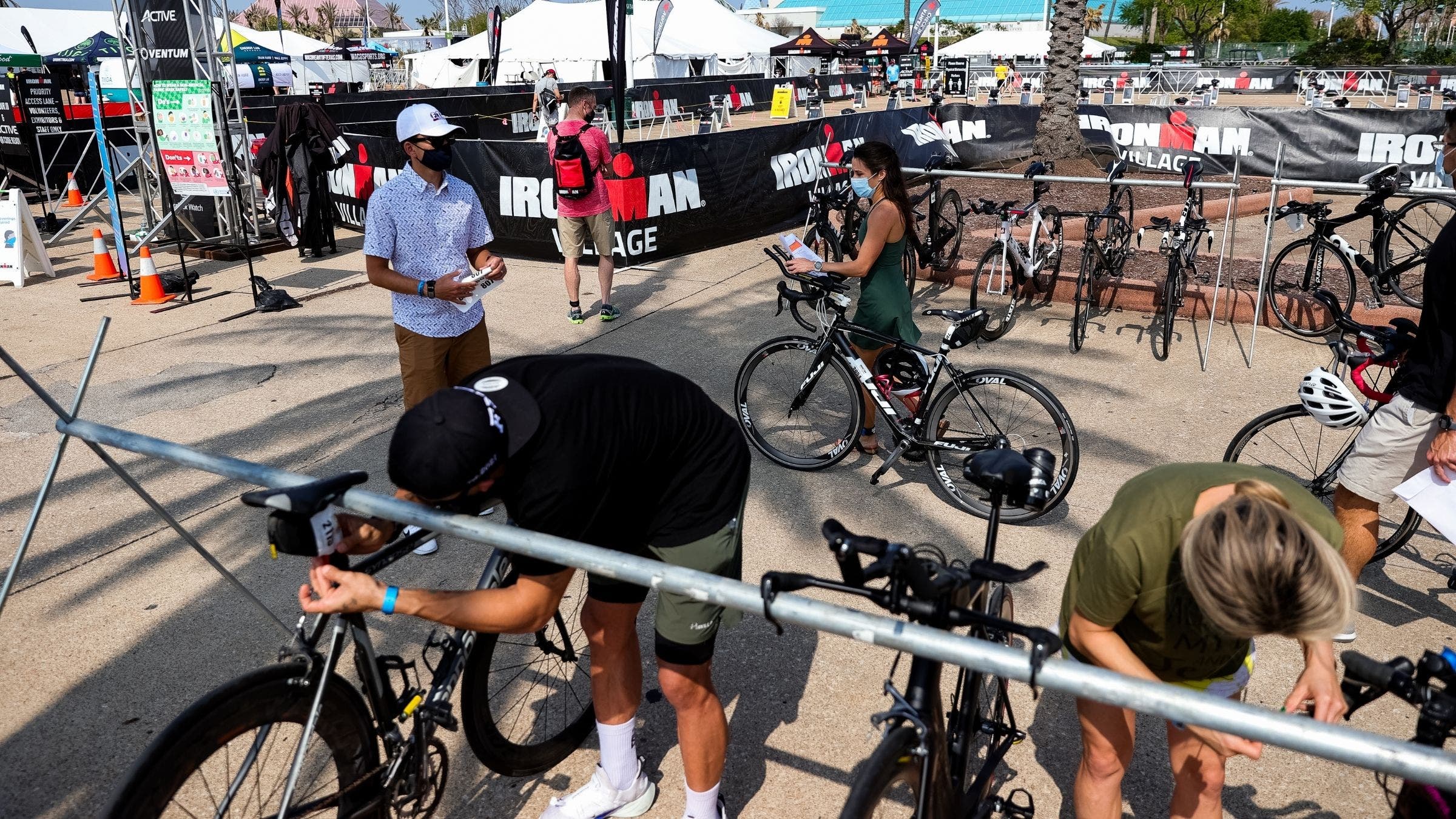 A triathlete makes his way through the Ironman 70.3 Texas transition area.