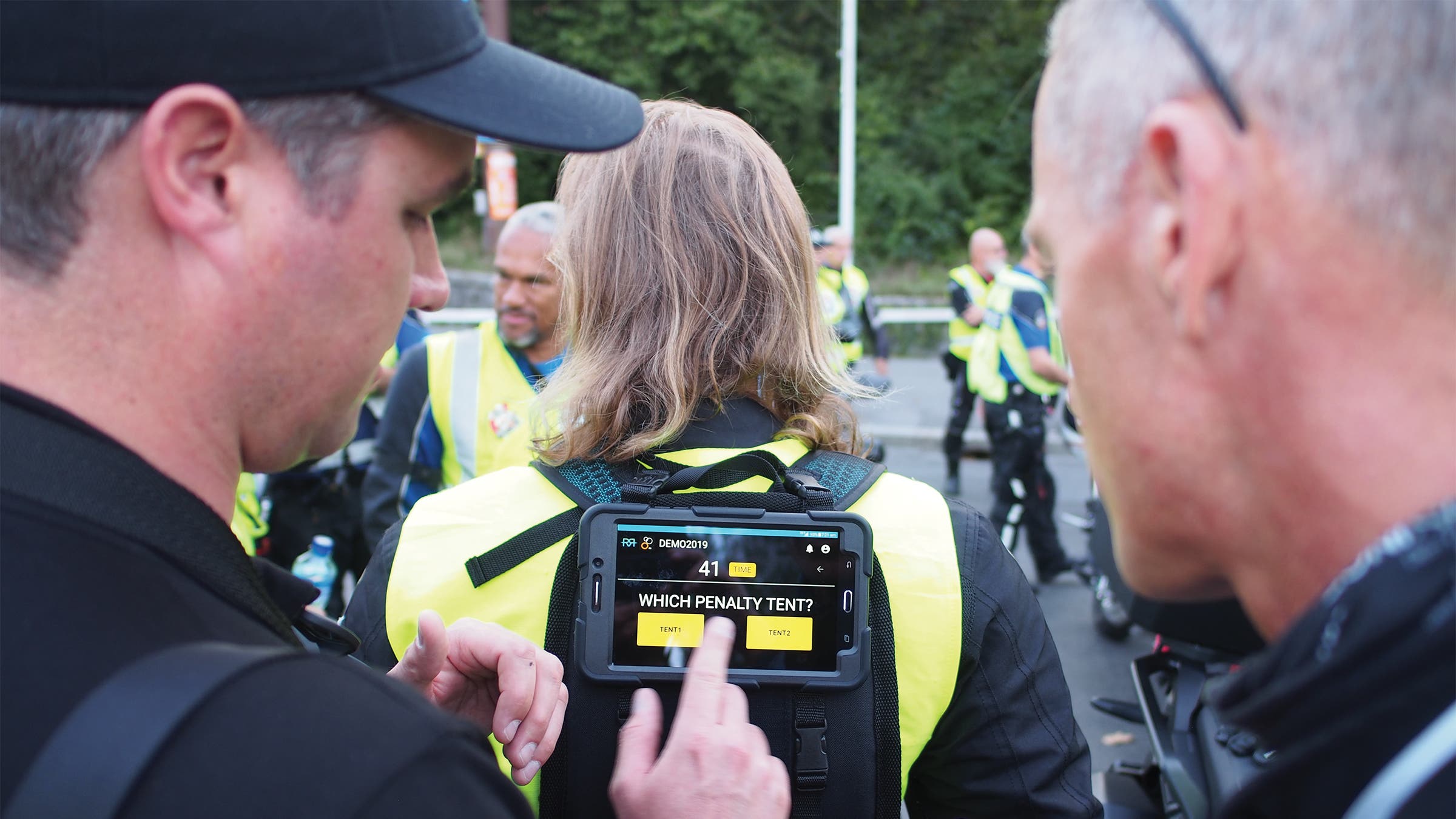 James Elvery showing a touch screen attached to a person's back
