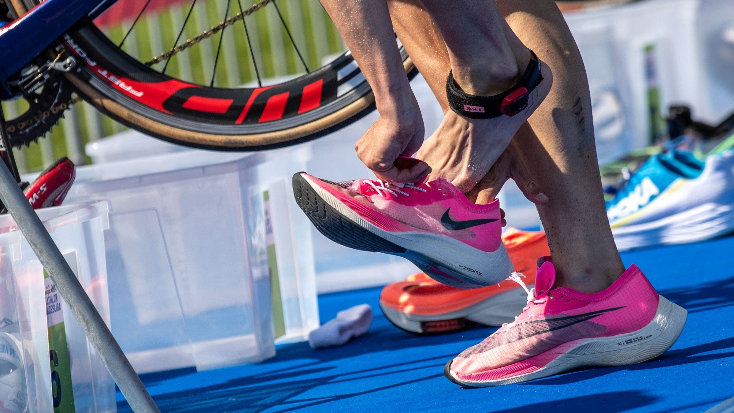 An athlete transitions from bike to run in a duathlon.