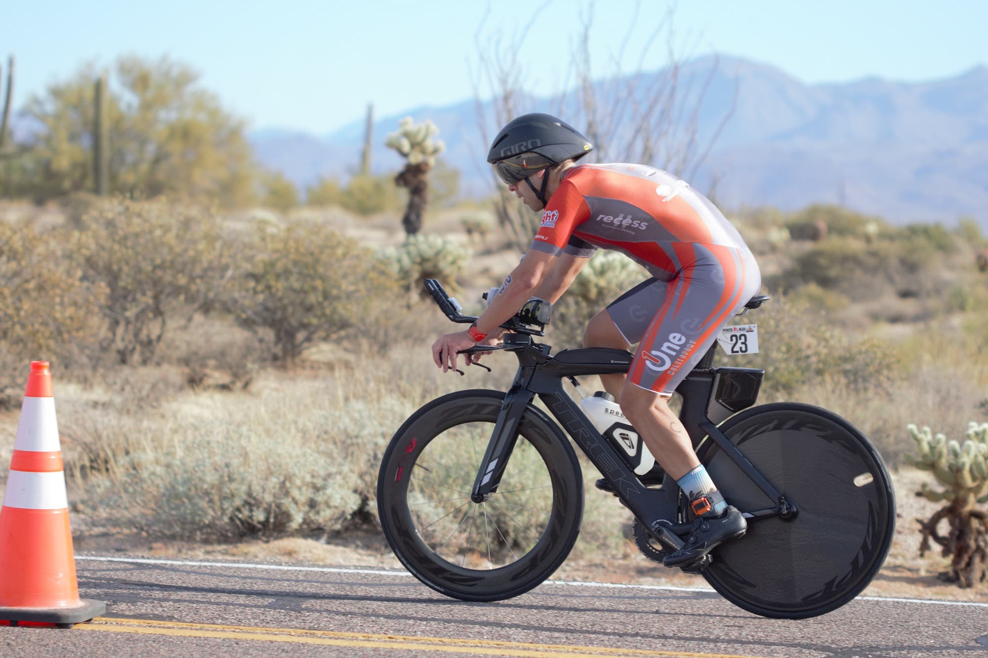 A man rides his tri bike through a duathlon course.
