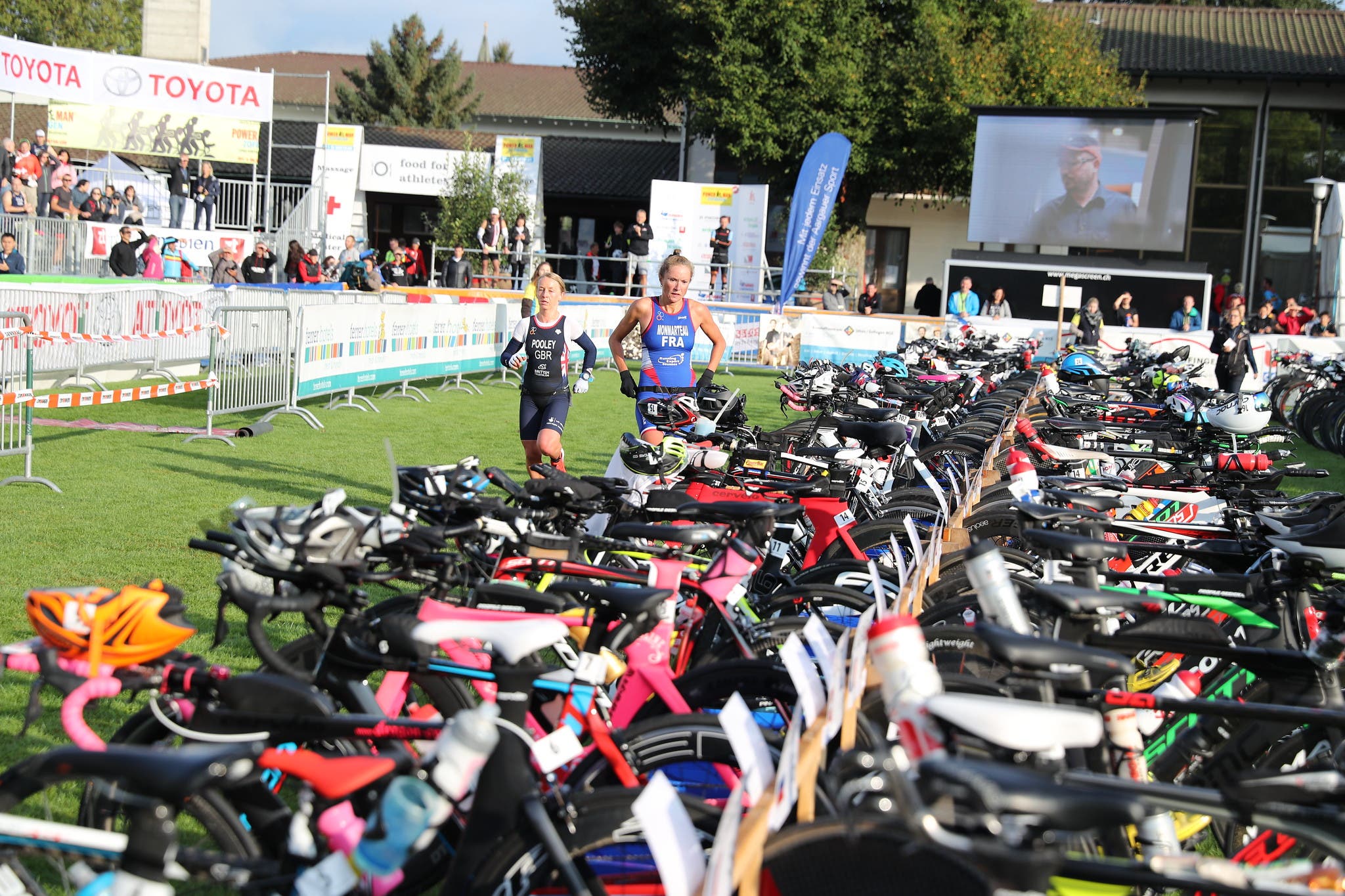 Women make their way through the transition area of a duathlon.