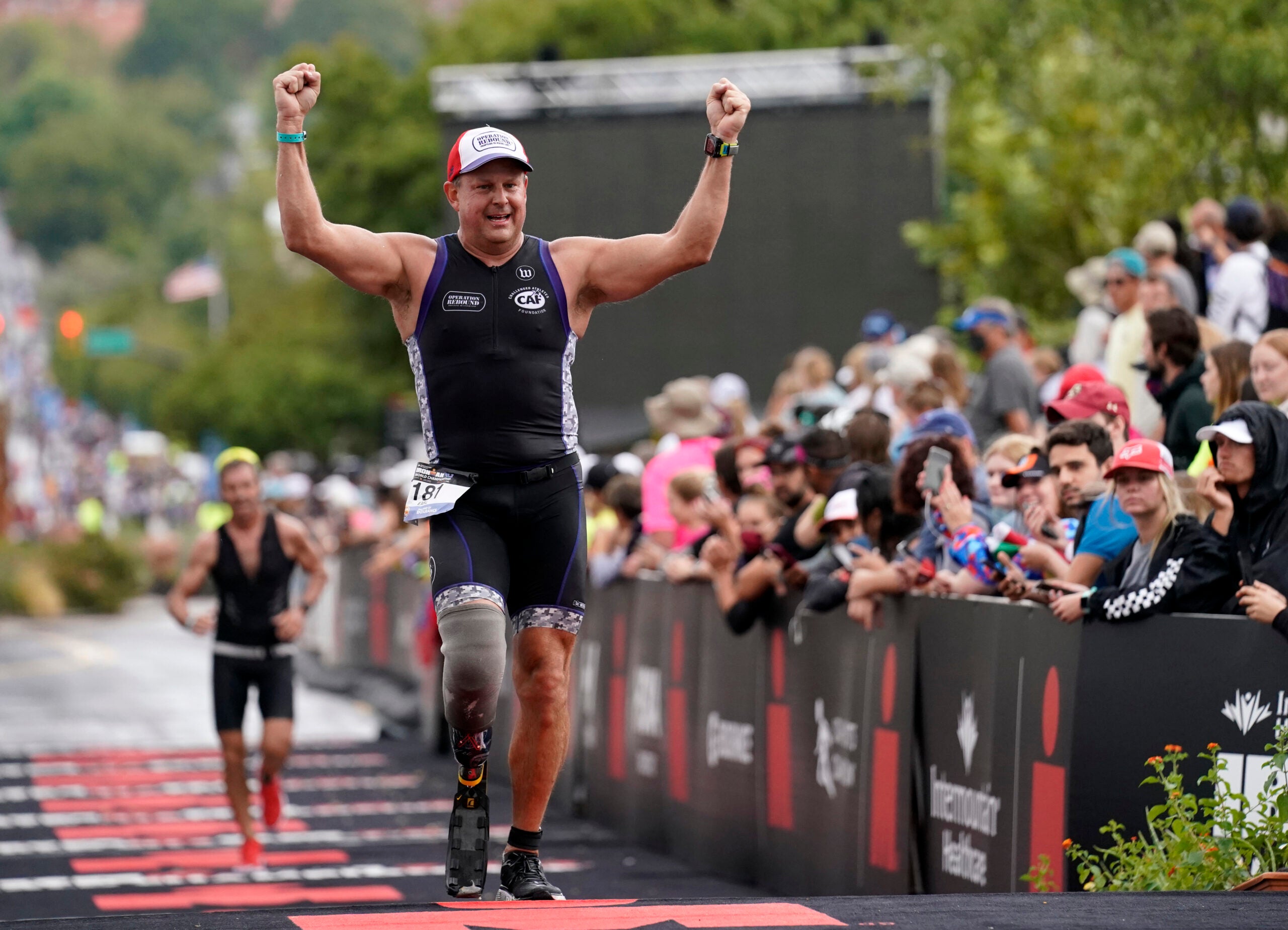 An athlete crosses the finish line of an Ironman 70.3 race