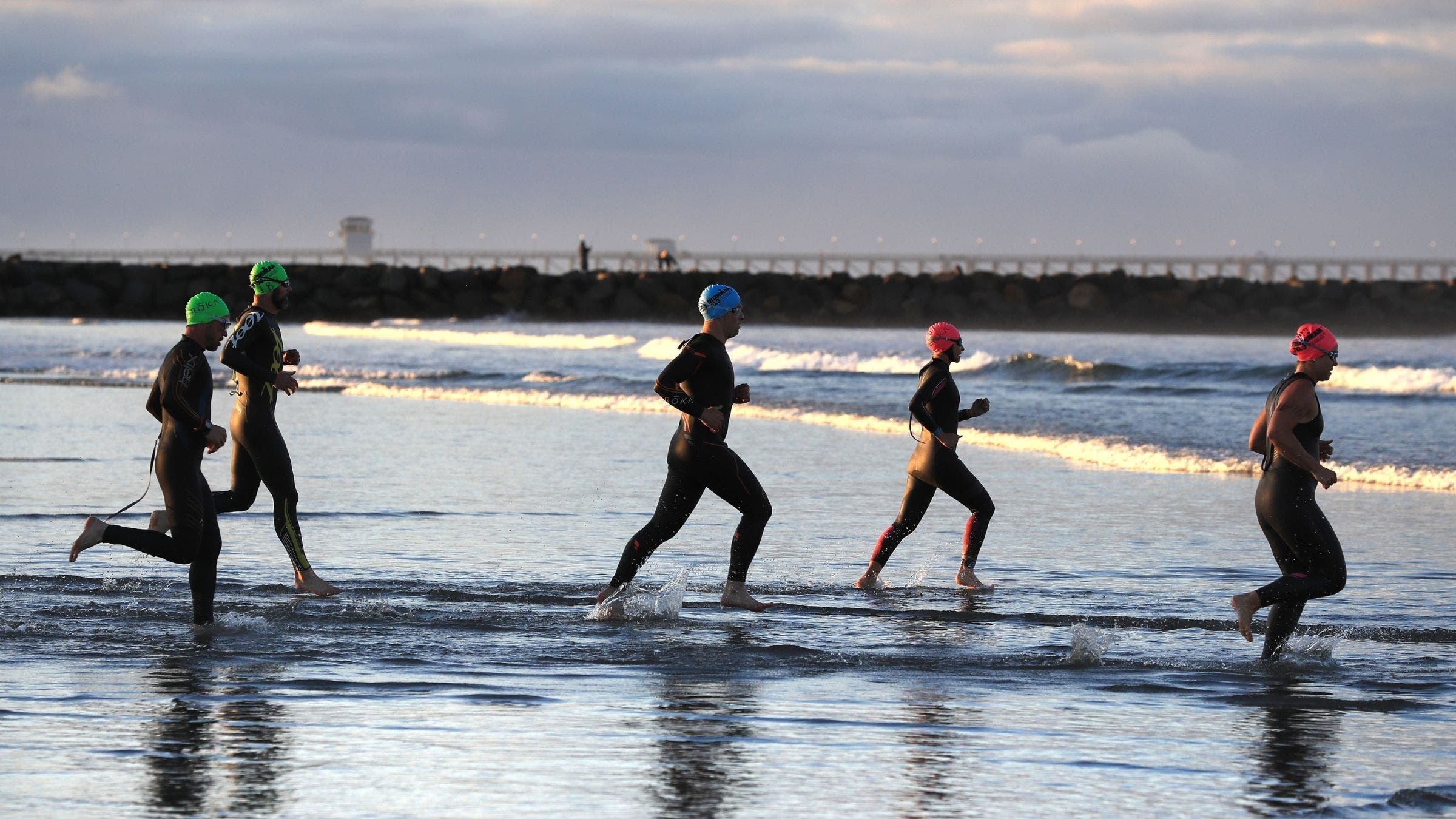 Athletes enter the swim course at Ironman 70.3 Oceanside
