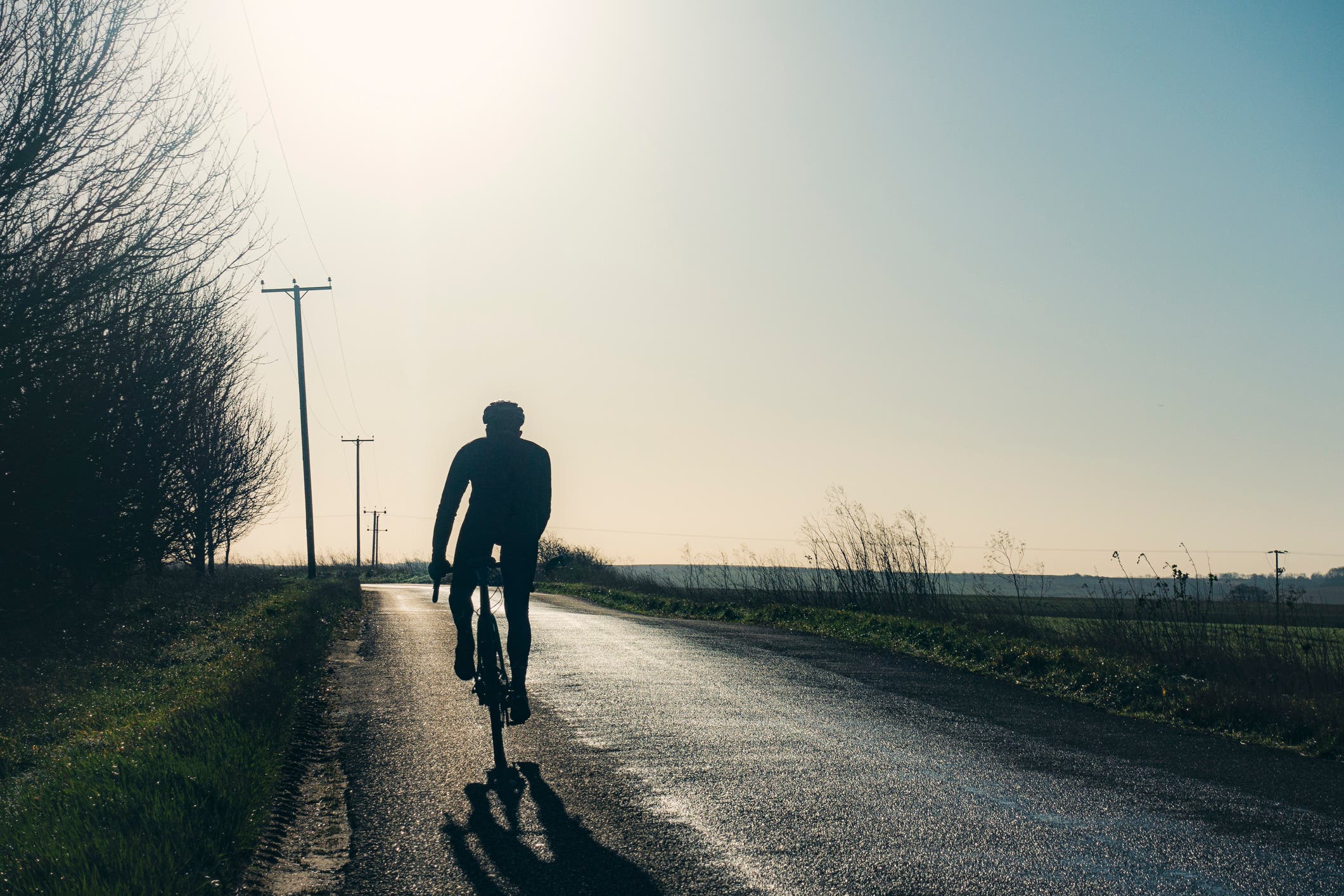 A man spends hours training for triathlon by riding his bike.
