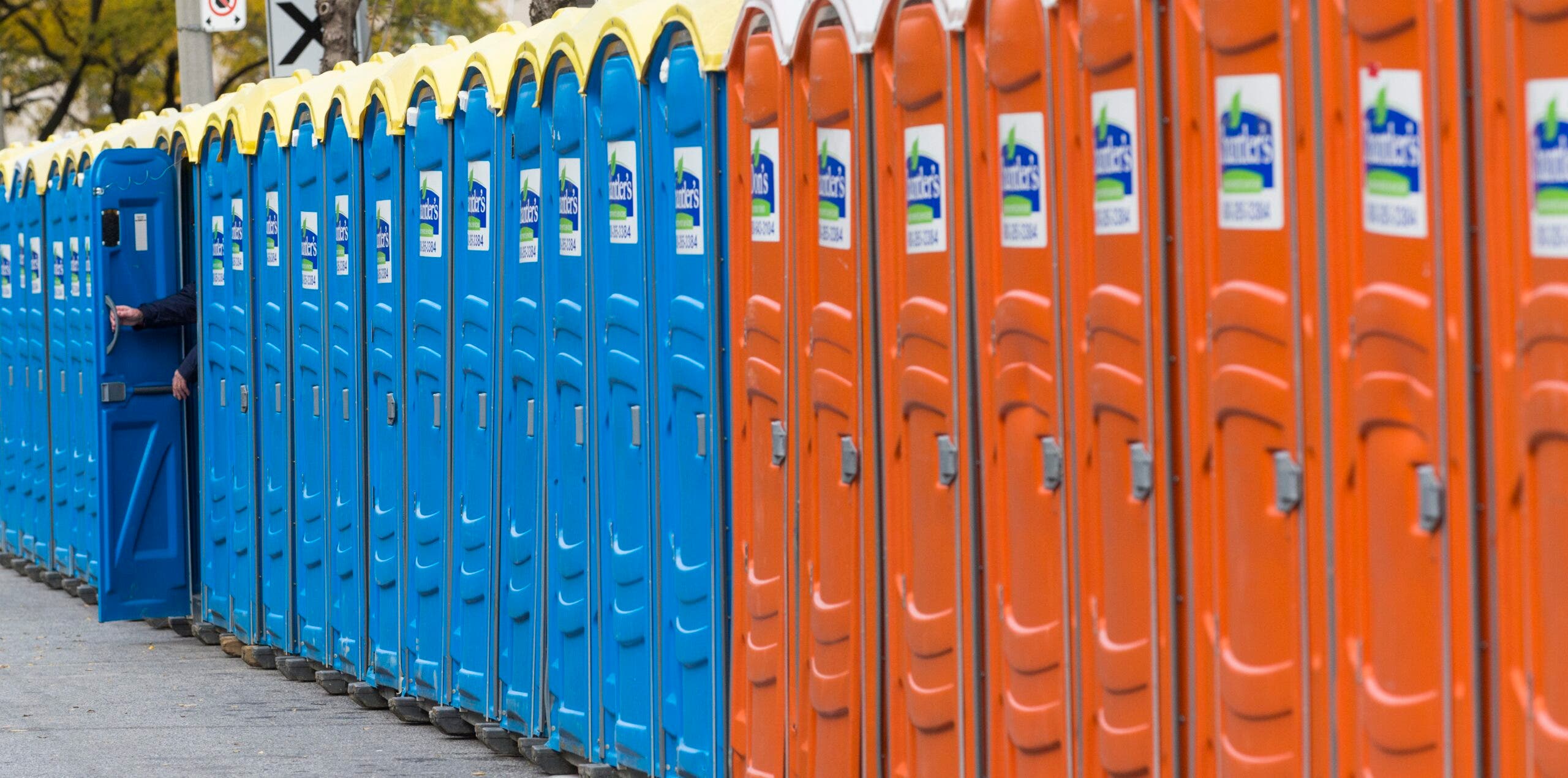 A row of port-a-potties at a race.