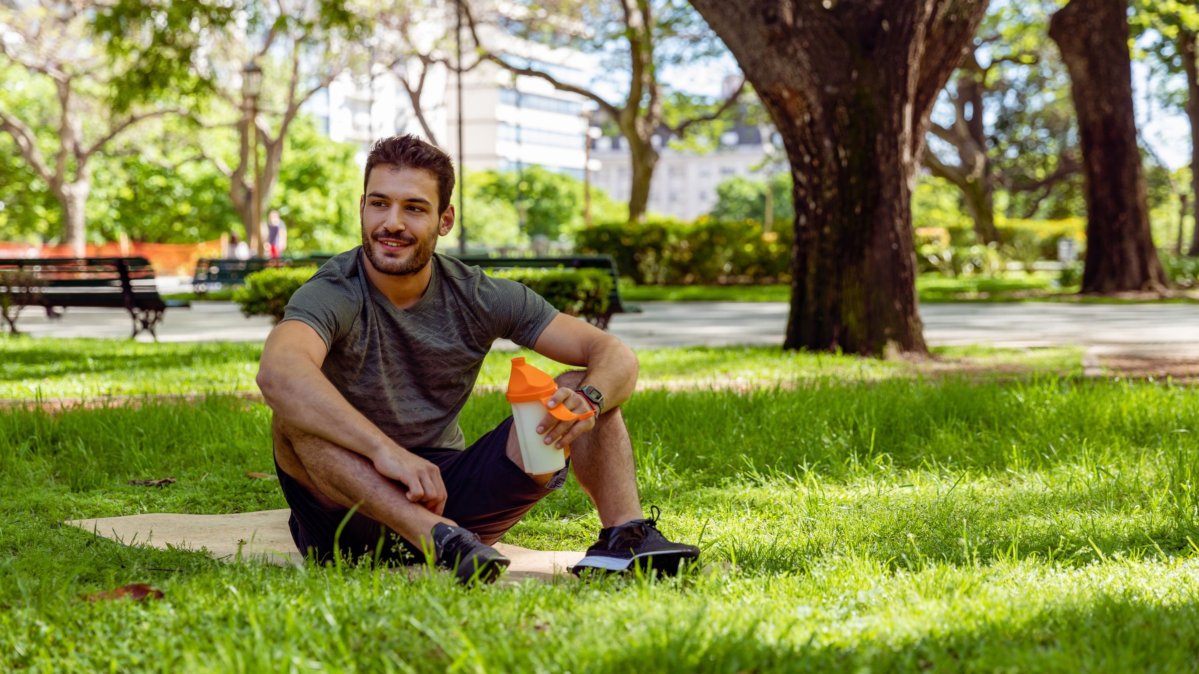 A male athlete drinks exogenous ketones from a shaker bottle after a workout. Many triathletes wonder what are exogenous ketones.