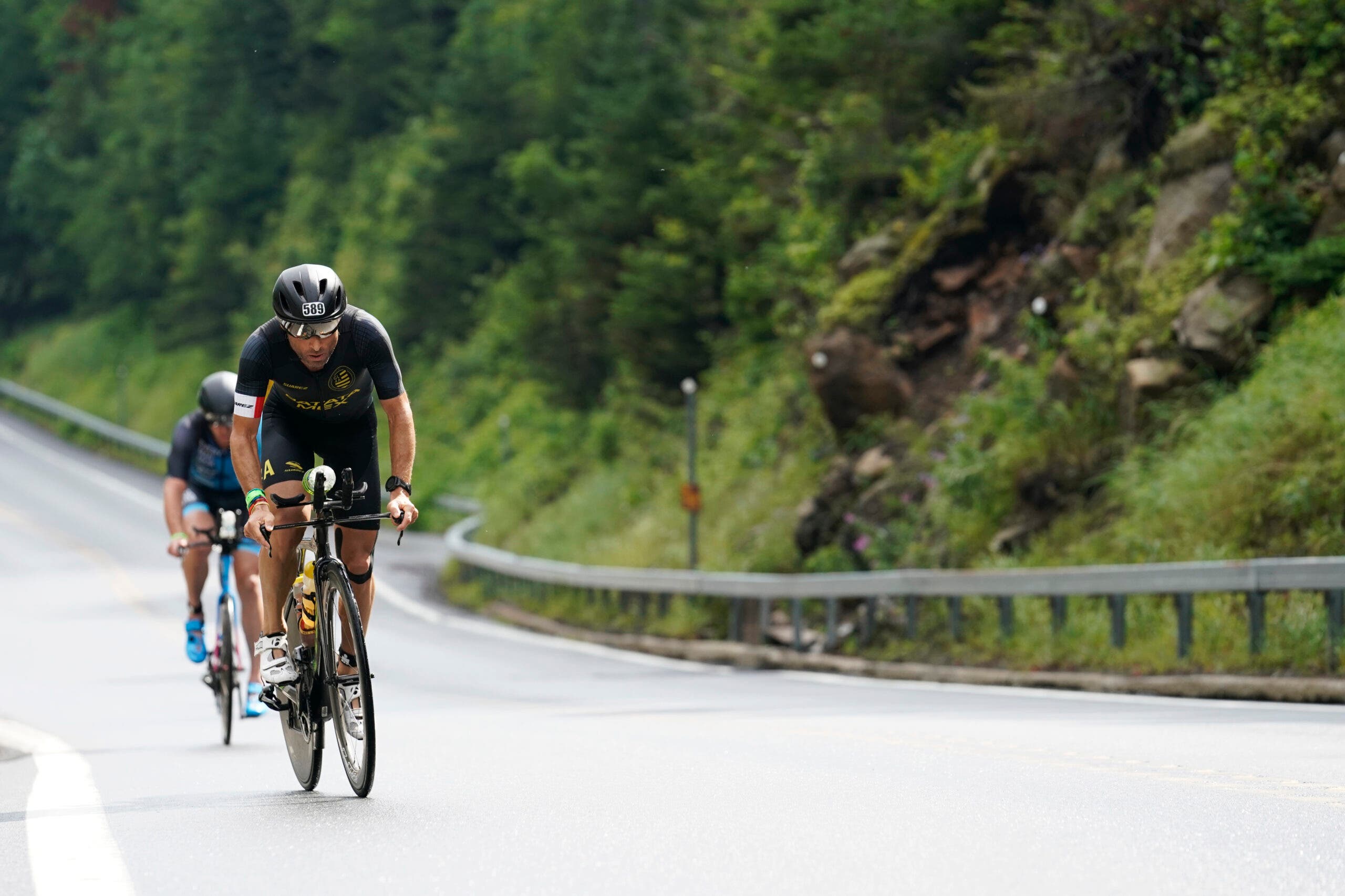 Athletes compete during the cycling portion of Ironman Lake Placid, one of the best Ironman and iron-distance triathlons in the USA.