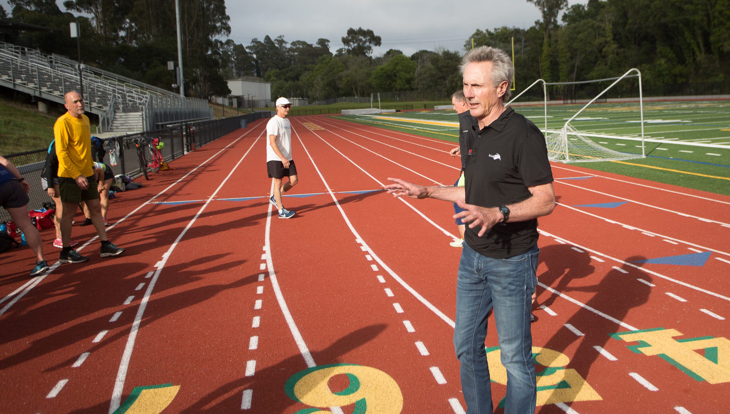 Triathlete legend Mark Allen coaching on the track