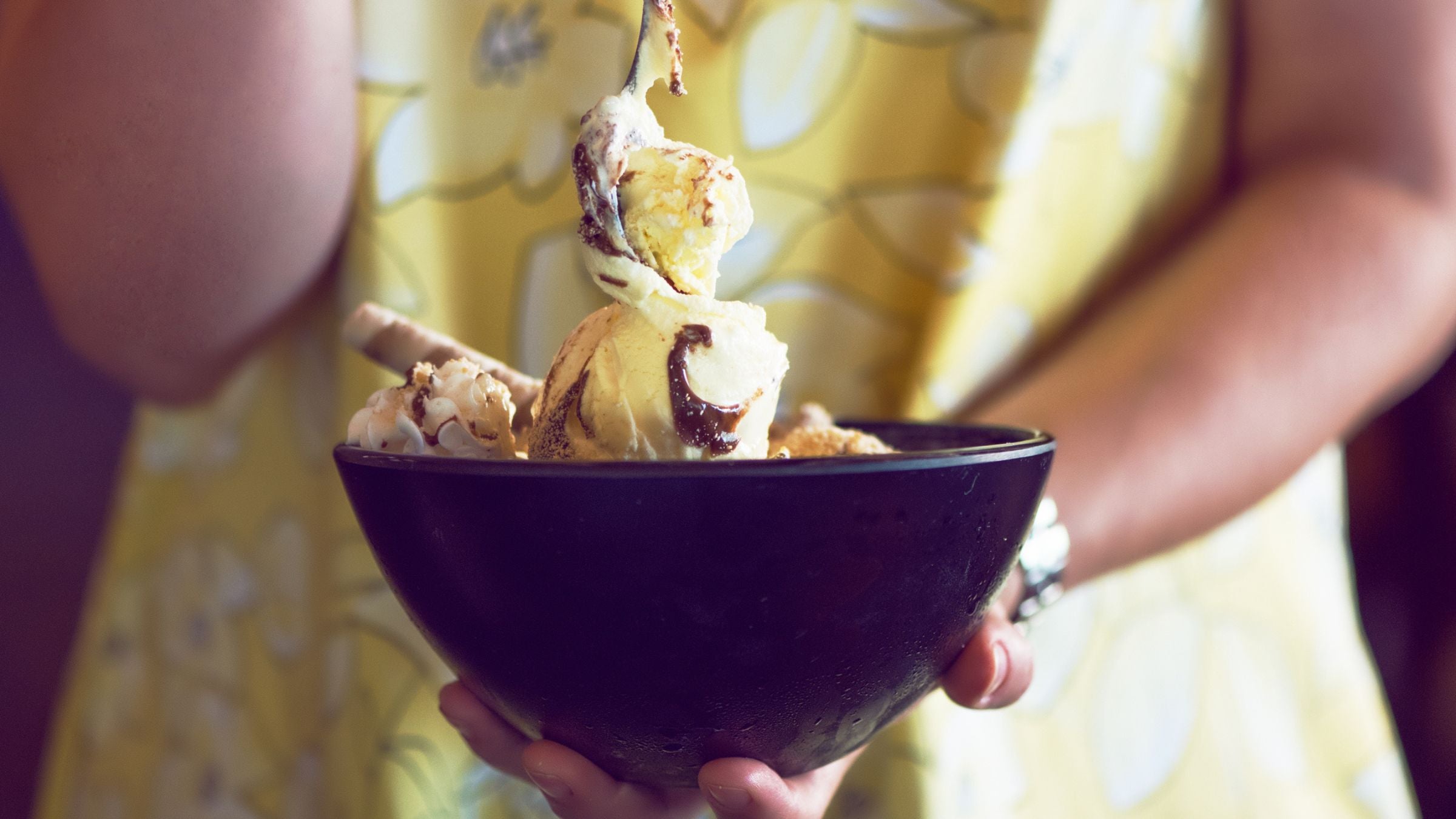 Spoon digging into an ice cream sundae, a cold and sweet adventure