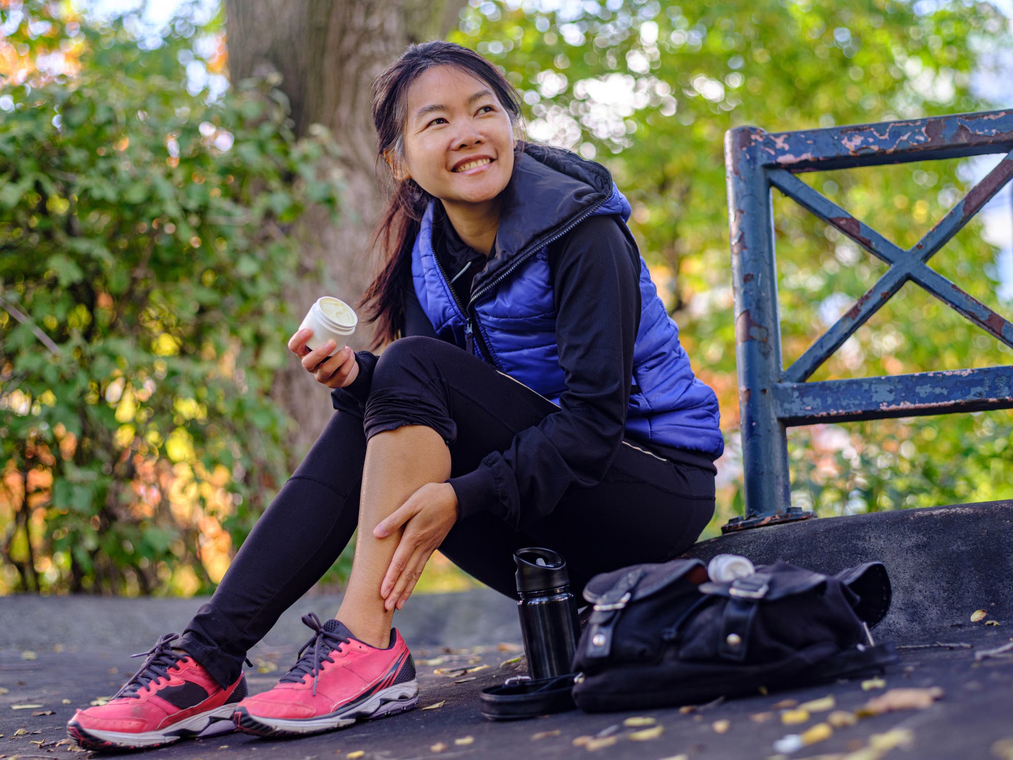 An athlete applies a CBD cream to an injury before running