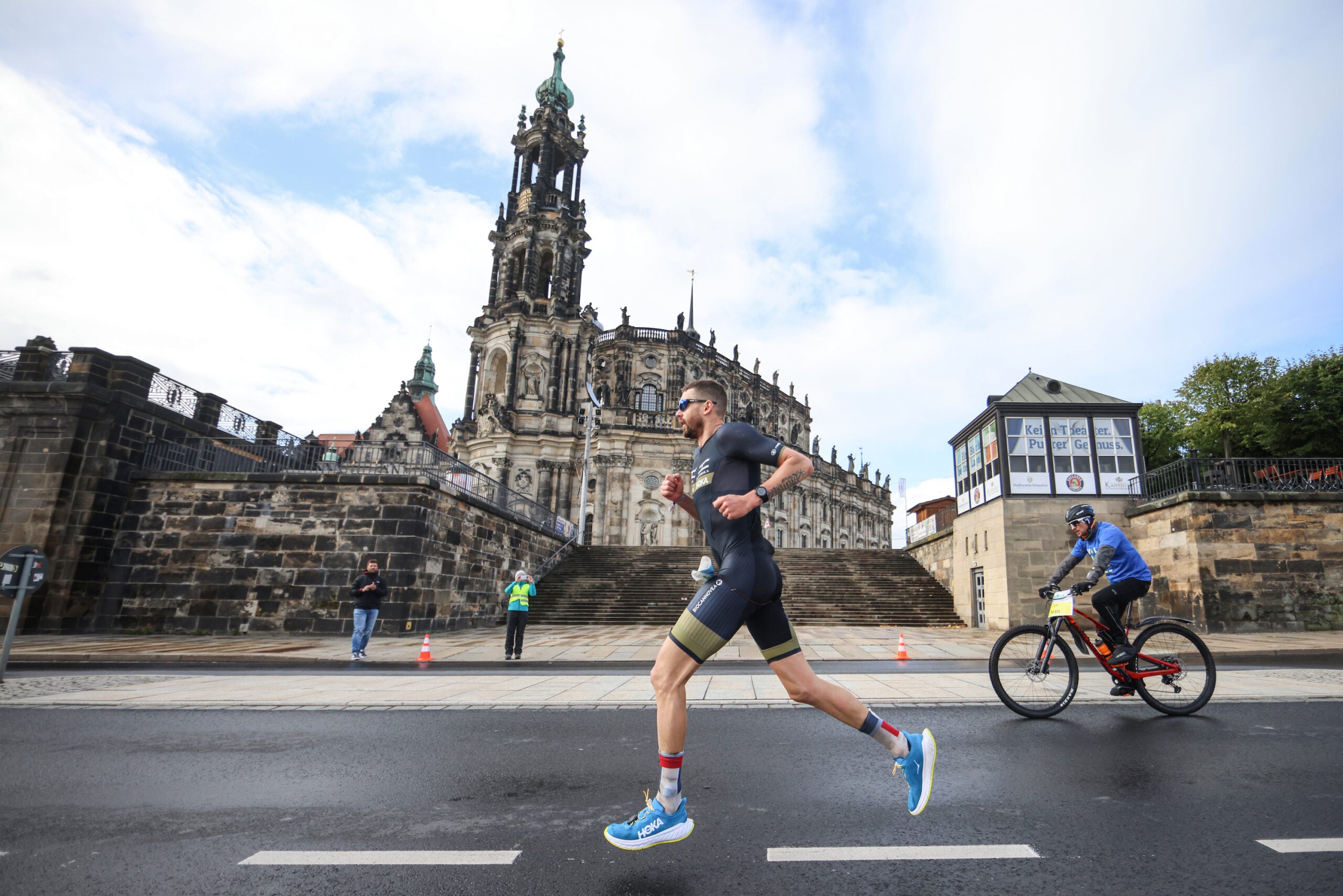 Franz Loeschke, a triathlete, runs in front of a church.
