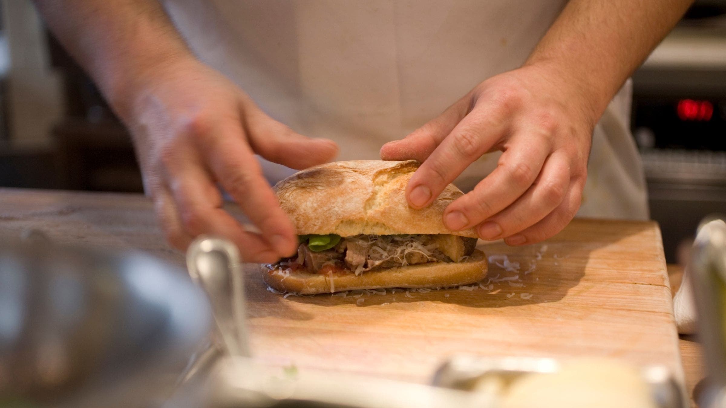 A man makes a healthy sandwich recipe for athletes