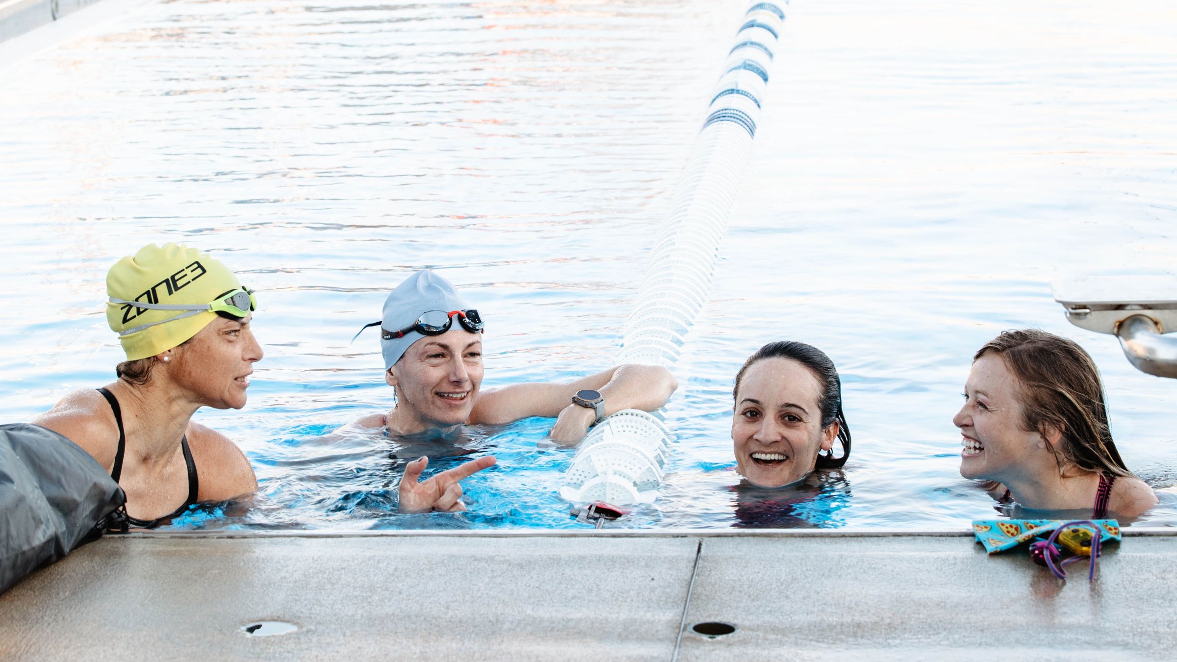Members of Octagon Elite Triathlon team chat after a practice swim.