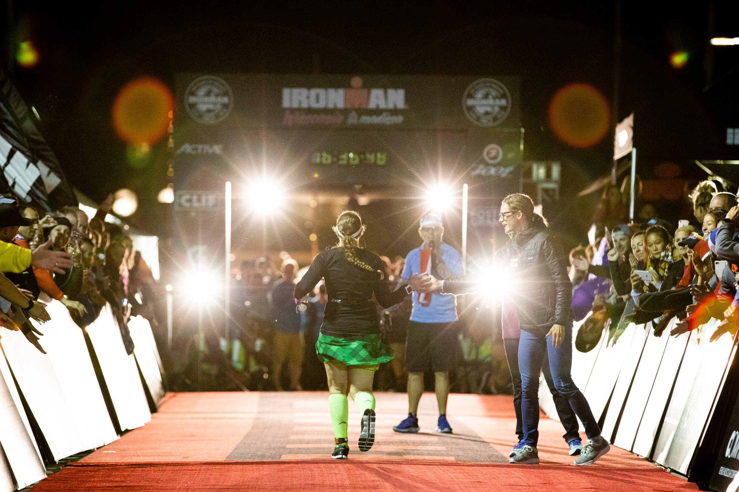 MADISON, WI - SEPTEMBER 09: Mike Reilly congratulates an anthlete during the Final Hour as they finish the IRONMAN Wisconsin on September 9, 2018 in Madison, Wisconsin. (Photo by Patrick McDermott/Getty Images)