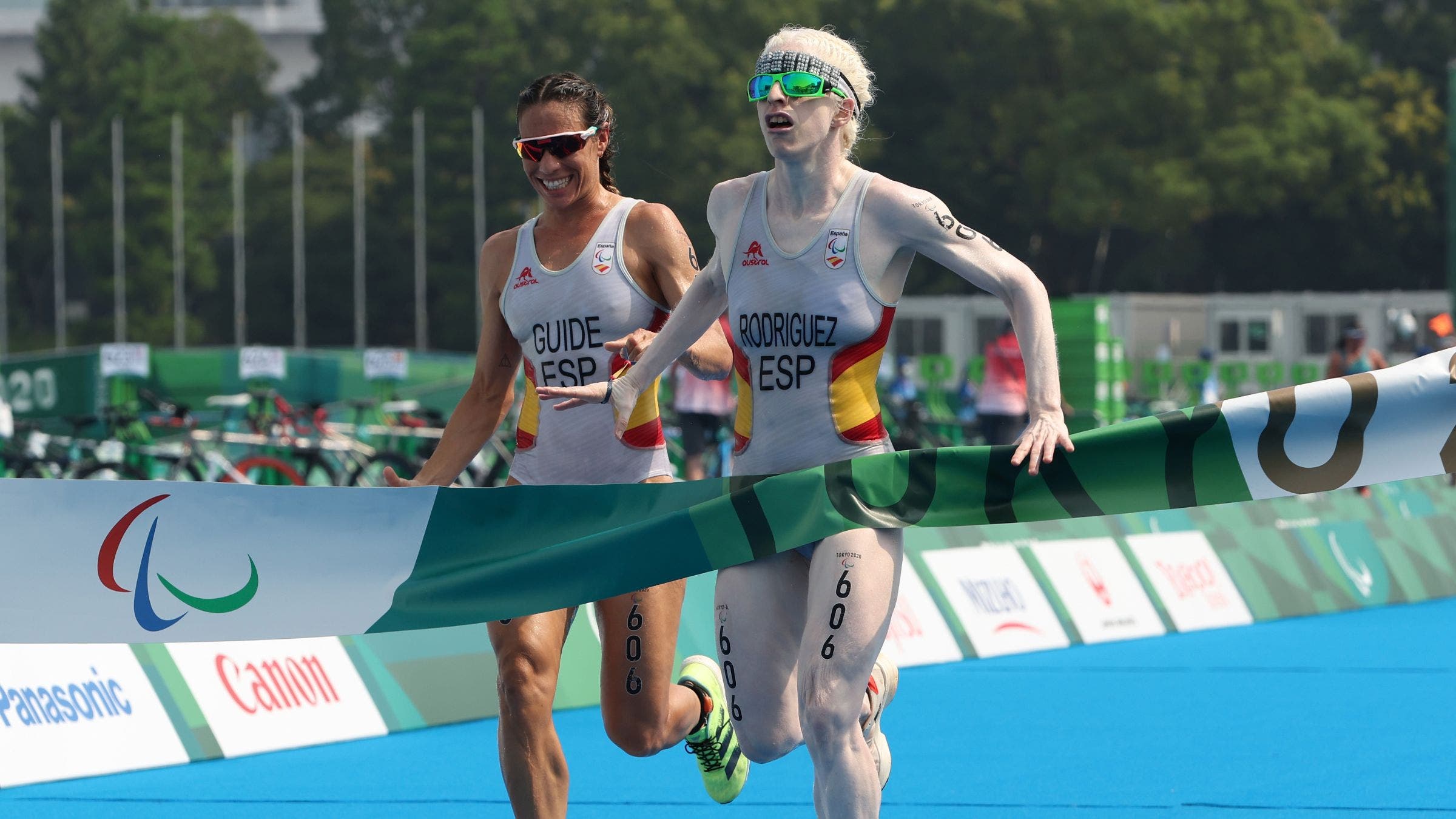 Susana Rodriguez, a triathlete with visual impairment, crosses the finish line at the Tokyo Olympics with her guide.