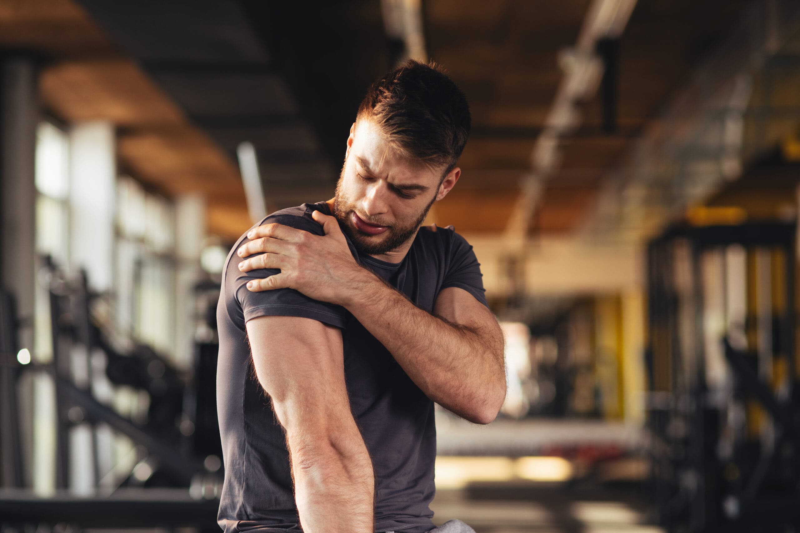 A man has Sore muscles after lifting weights