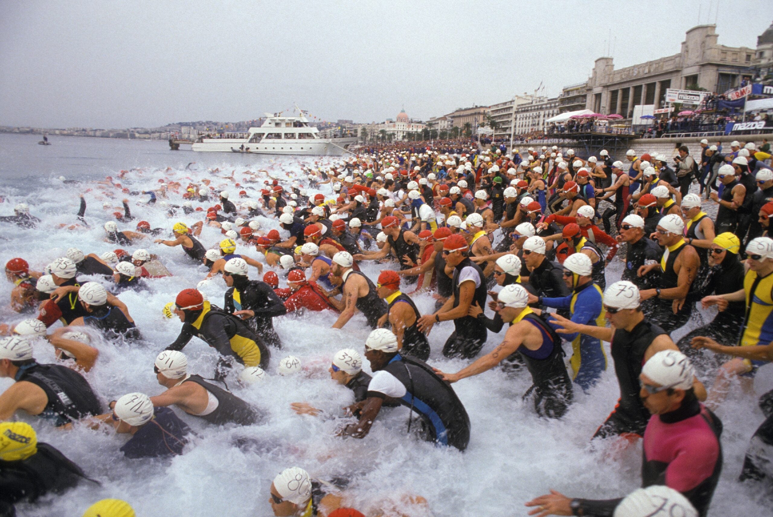 Triathlon competitors dive in at the Nice triathlon on October 25, 1987.